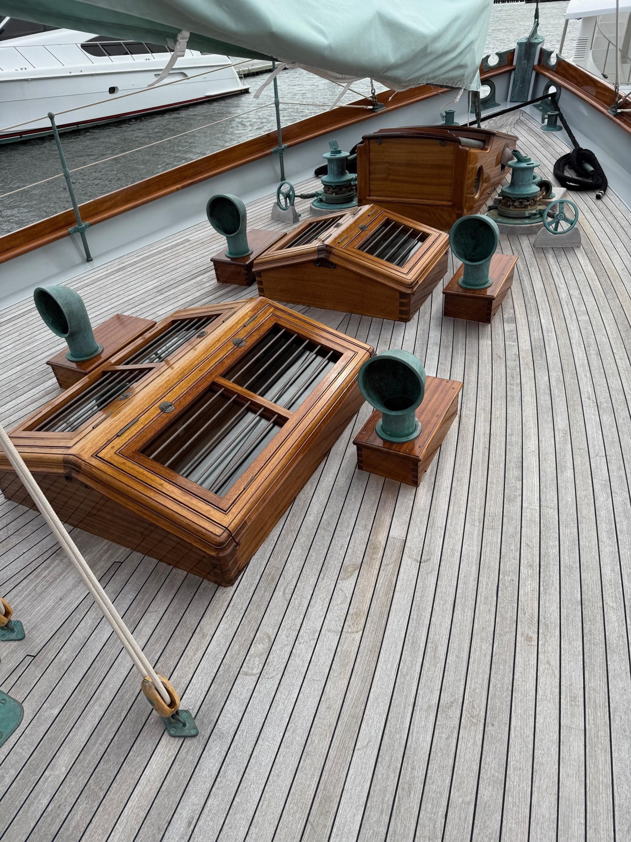 Wooden deck of a 1938 Alden yacht, featuring custom design elements and vintage fittings.