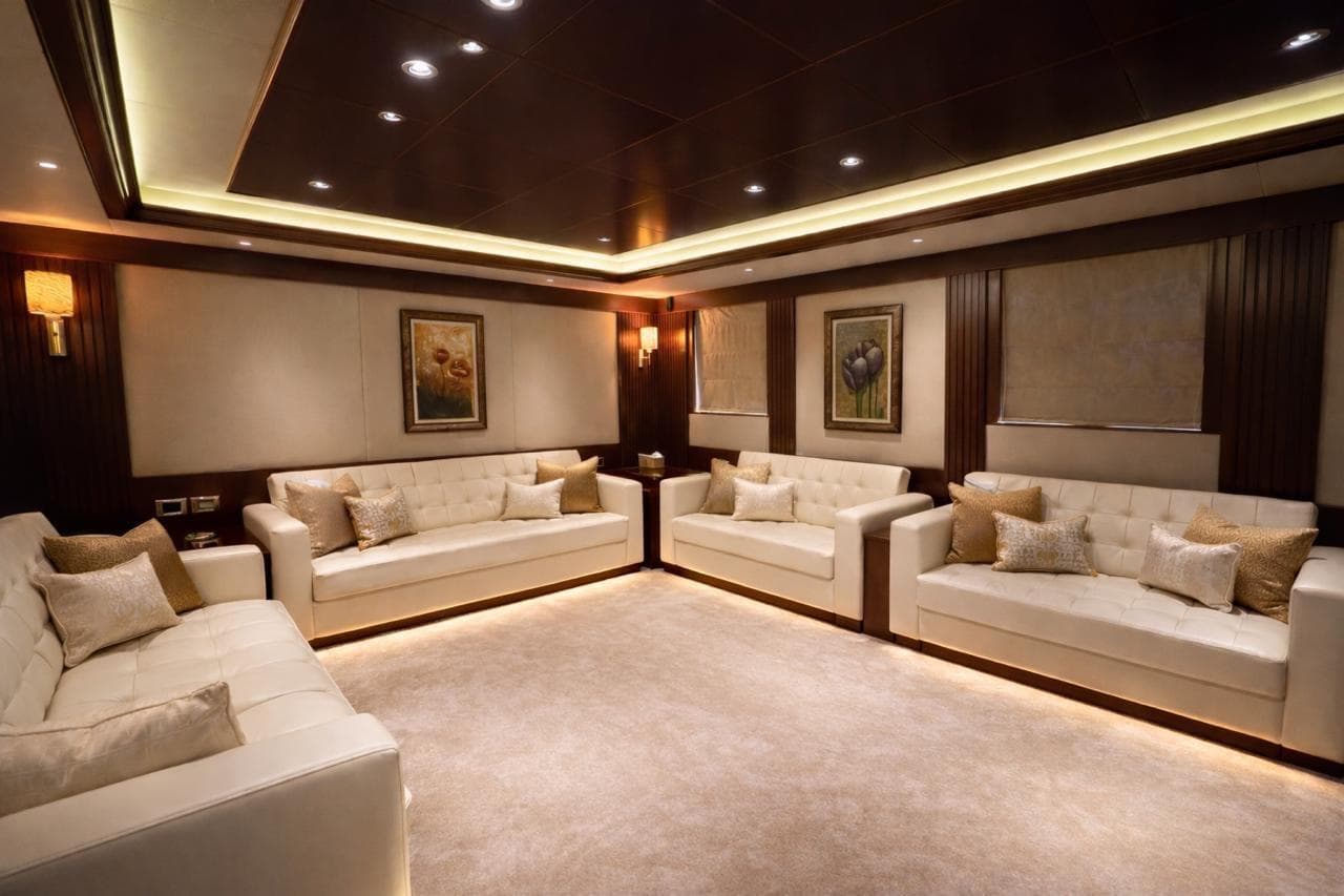 Luxurious yacht interior with elegant sofas, ambient lighting, and framed artwork, Riviera 2010 model.