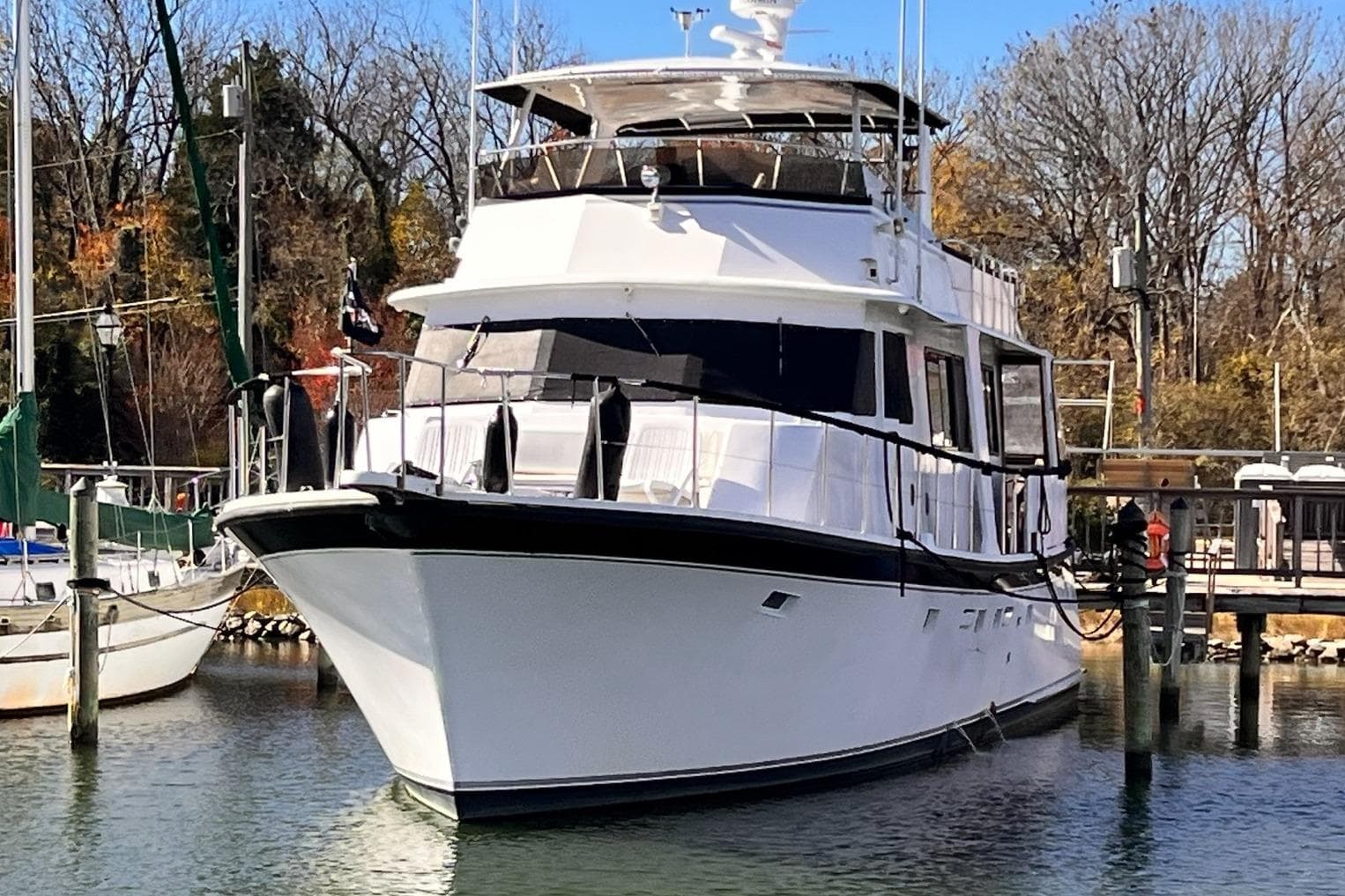 1985 Hartman-Palmer 60 Flush Deck Motor Yacht docked in a serene marina.