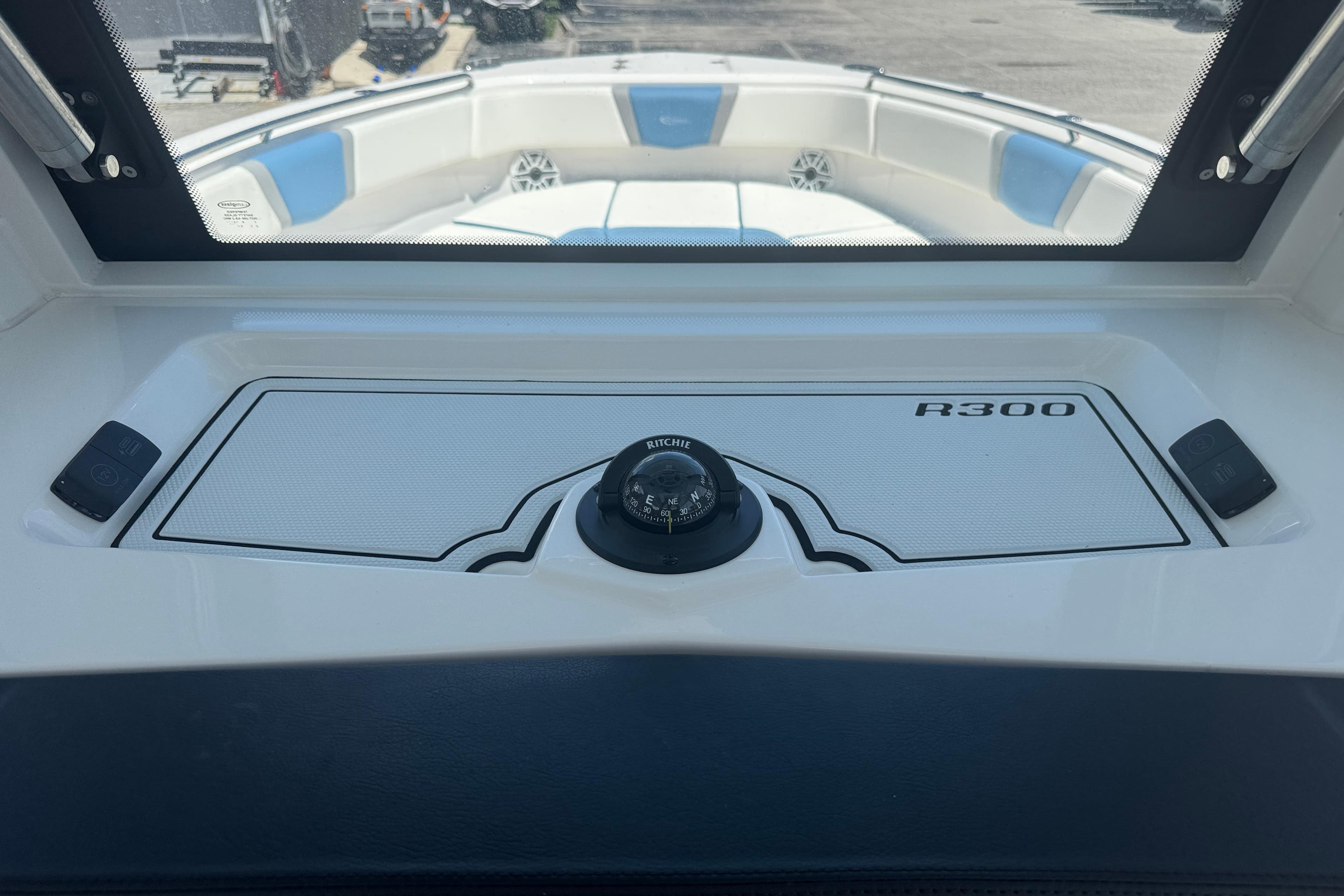 2026 Robalo R300 Center Console boat interior with compass and seating.