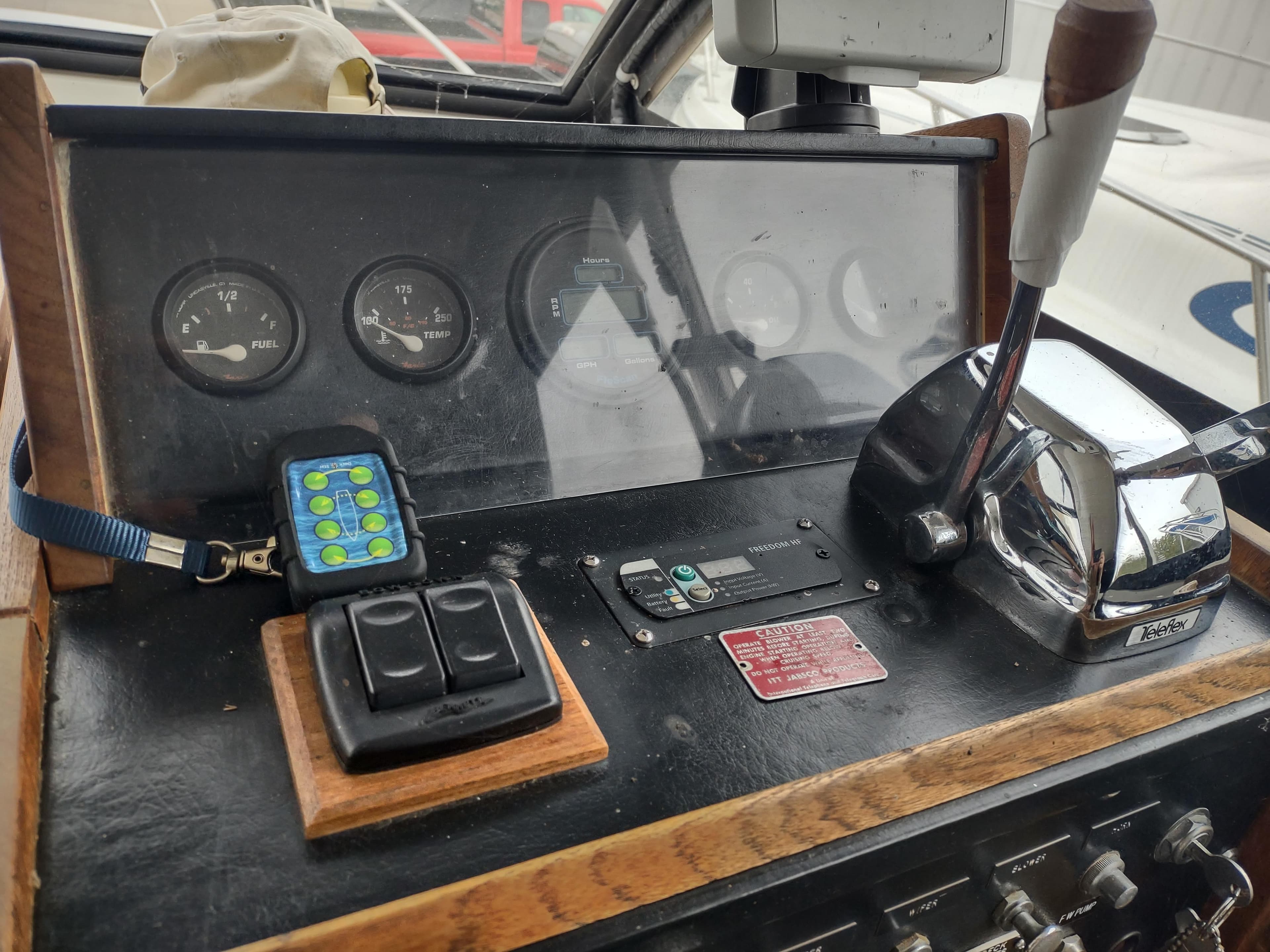 1976 Trojan 260 Hardtop Express boat dashboard with gauges and controls.