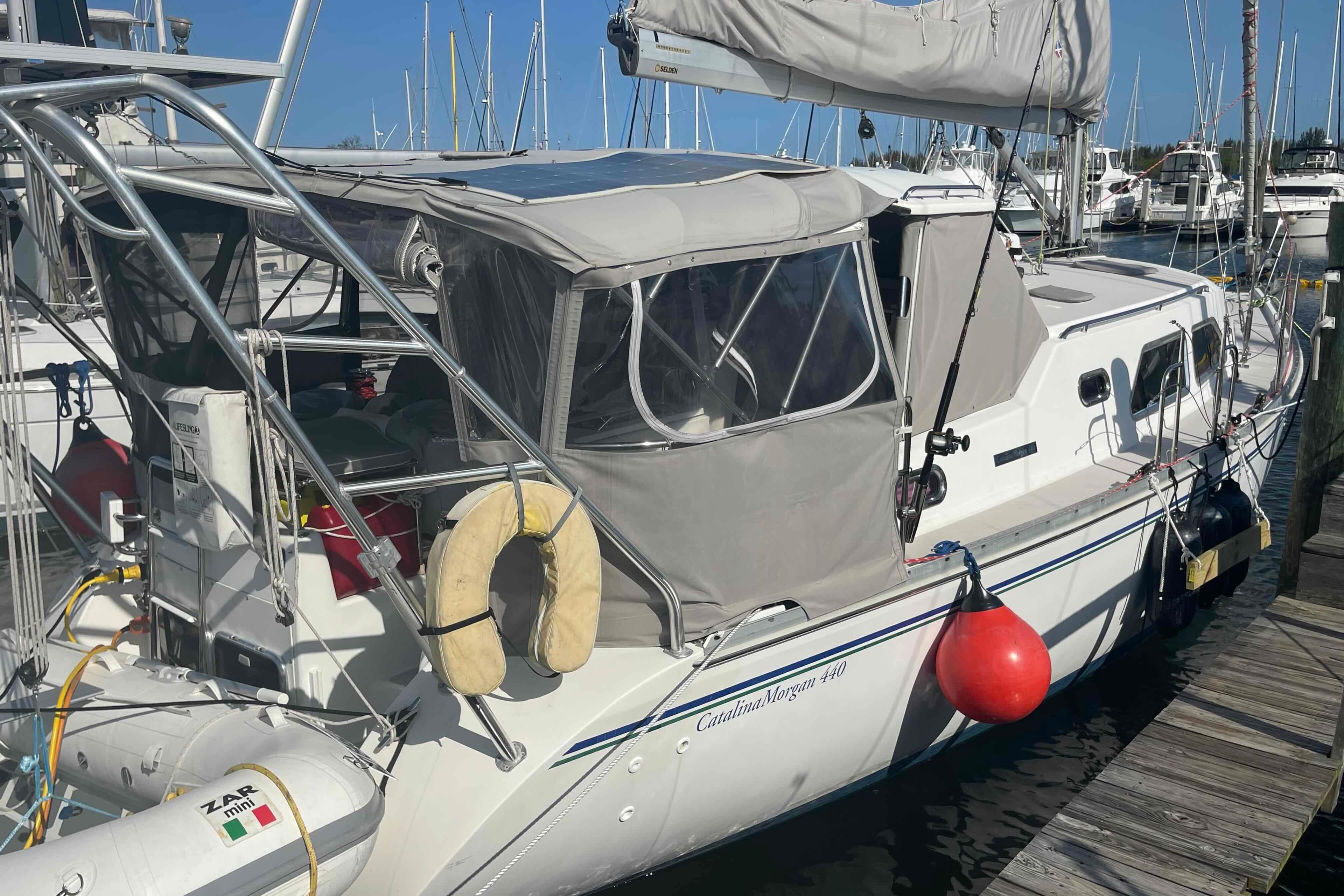 Sailboat Catalina Morgan 440, 2013 model, docked at marina with protective canopy.