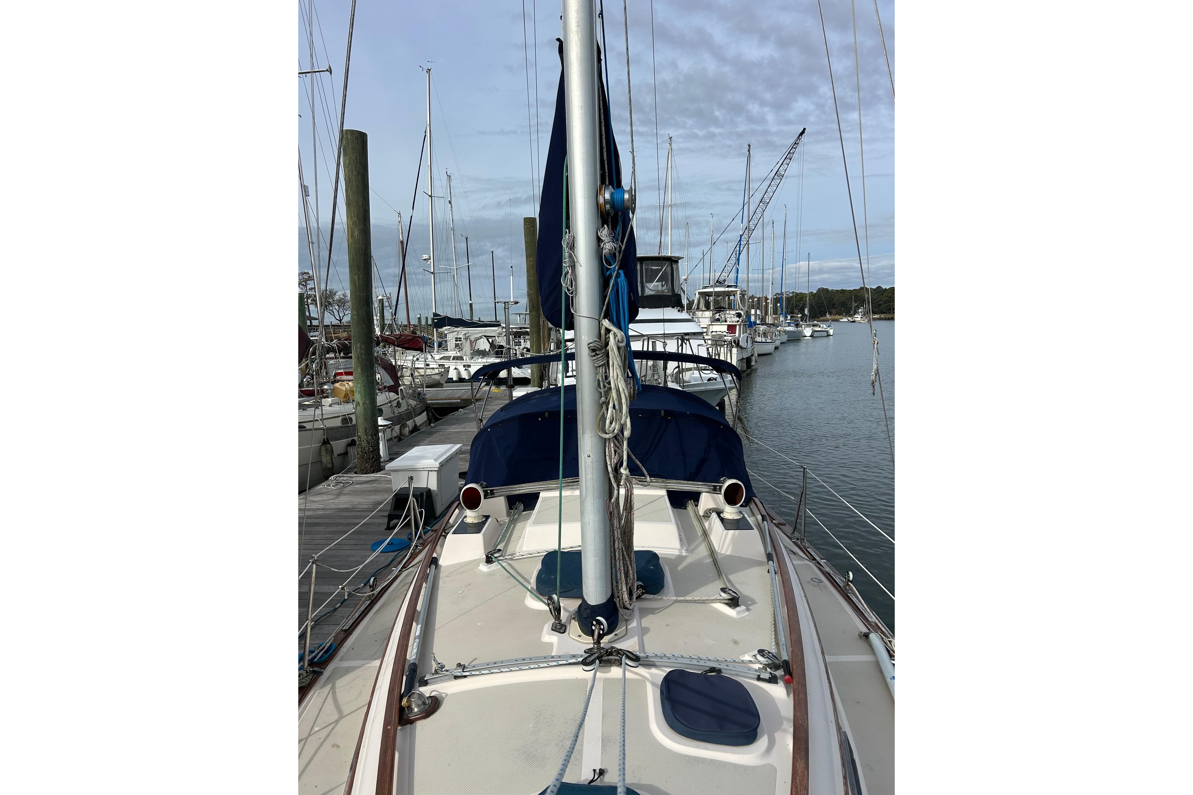 Sailboat docked at marina, Island Packet 29, 1997 model, clear sky.