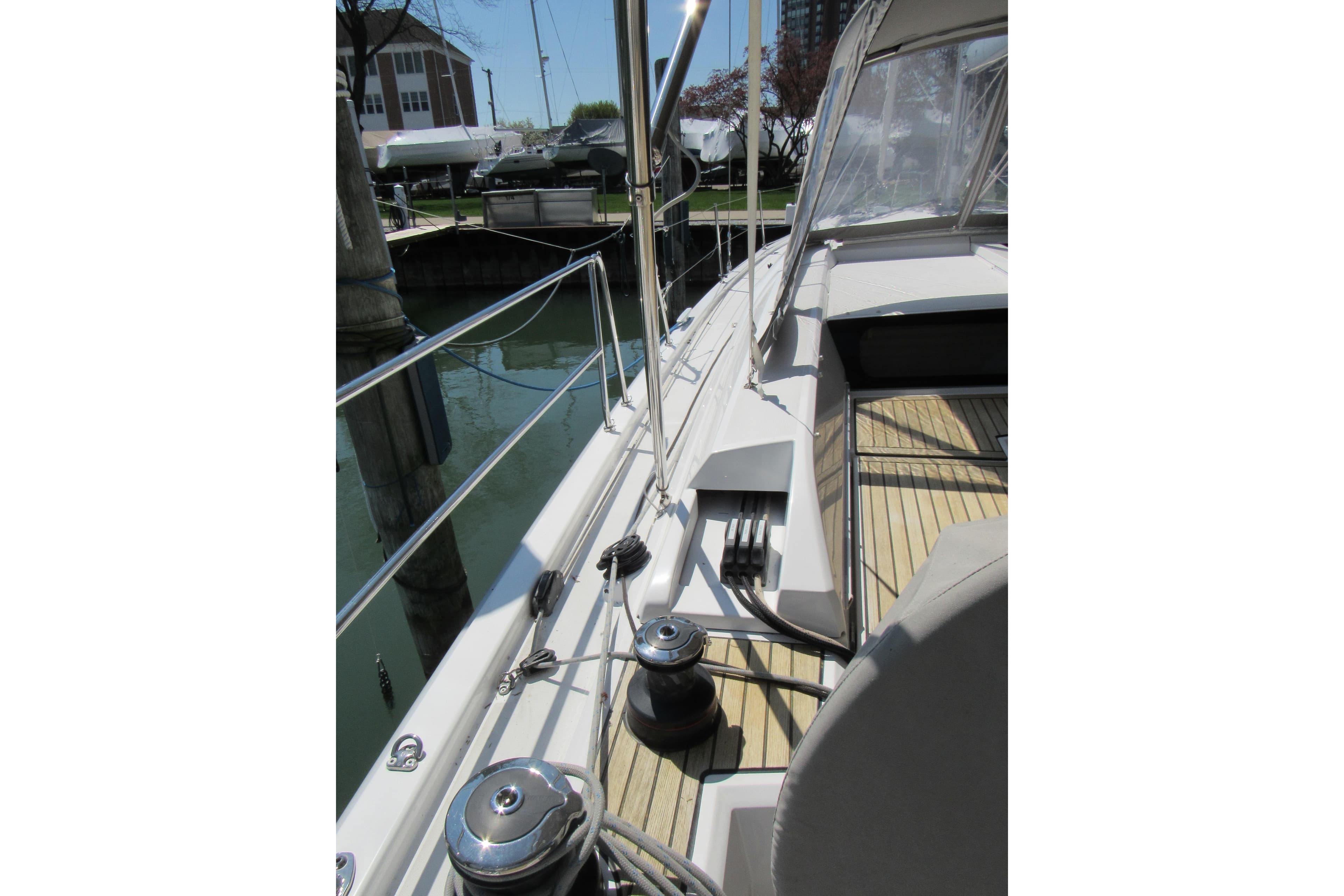 2020 Beneteau Oceanis 46.1 yacht deck with winches and railing in marina setting.