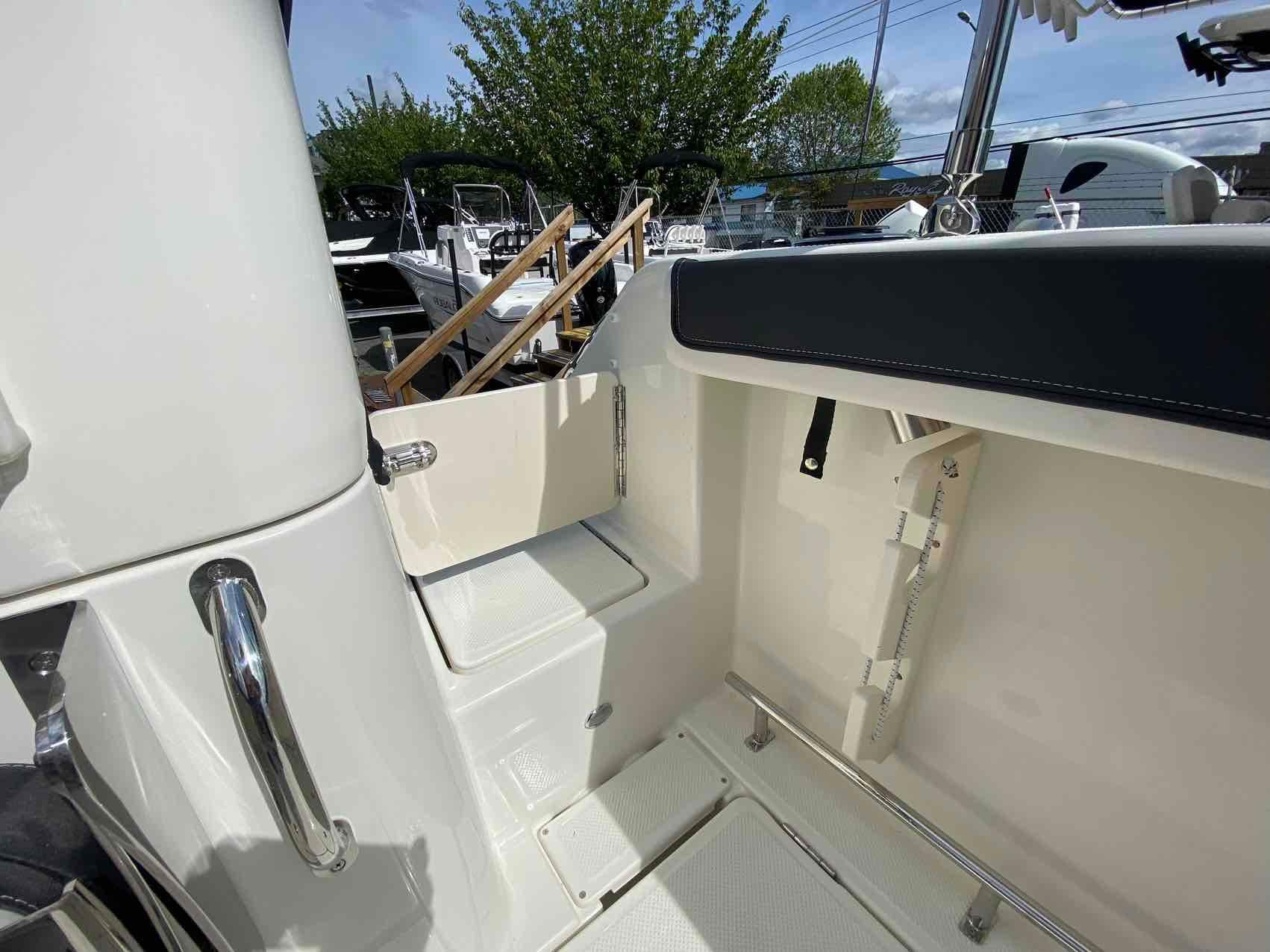 2024 Bayliner Trophy T25 Pilothouse interior with seating and storage, showcasing modern design.