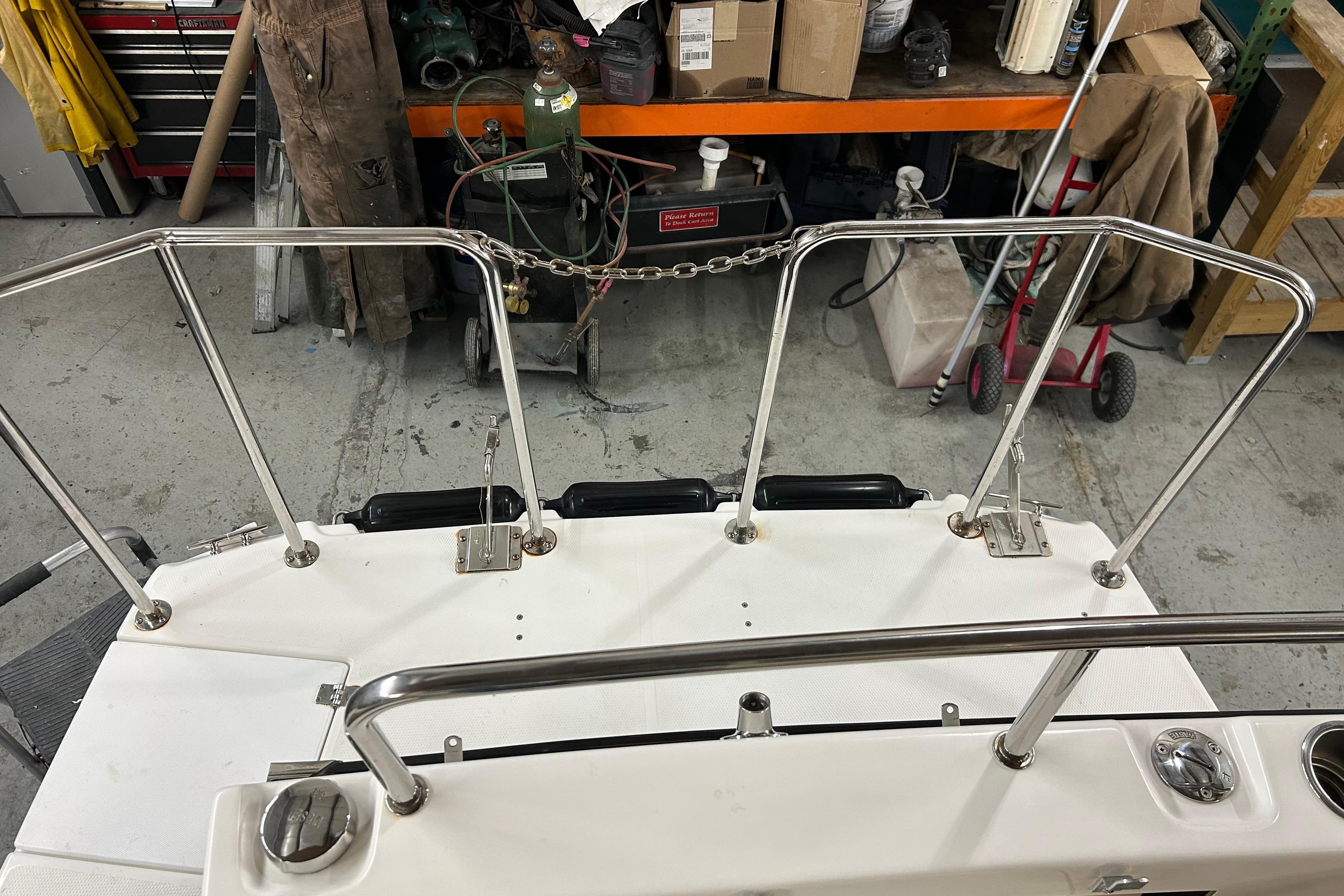 2017 Ranger Tugs R-25 SC boat deck with stainless steel railings in a workshop.