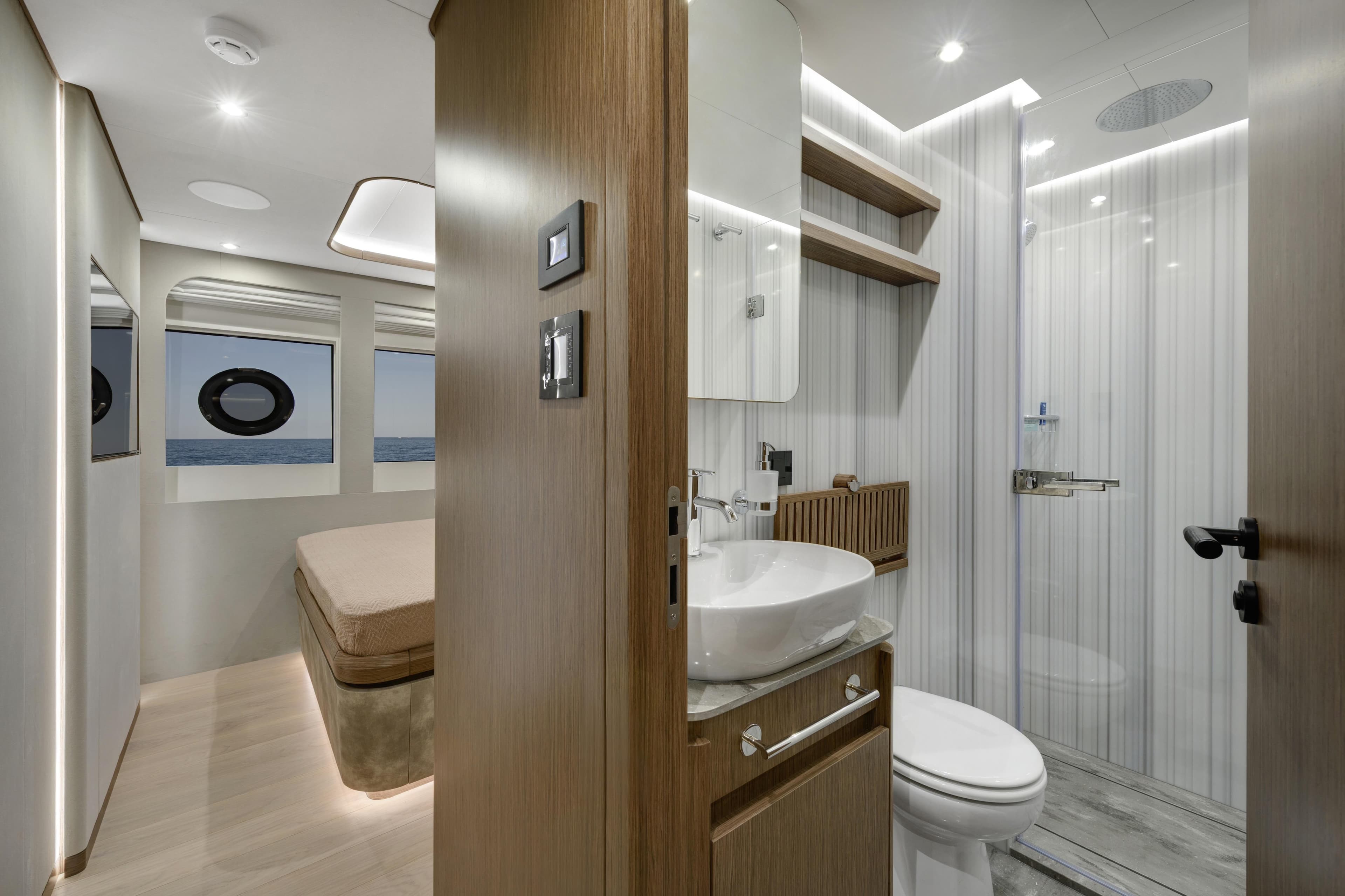 Luxurious interior of 2027 Lazzara LPC 300 yacht featuring modern bathroom and bedroom.