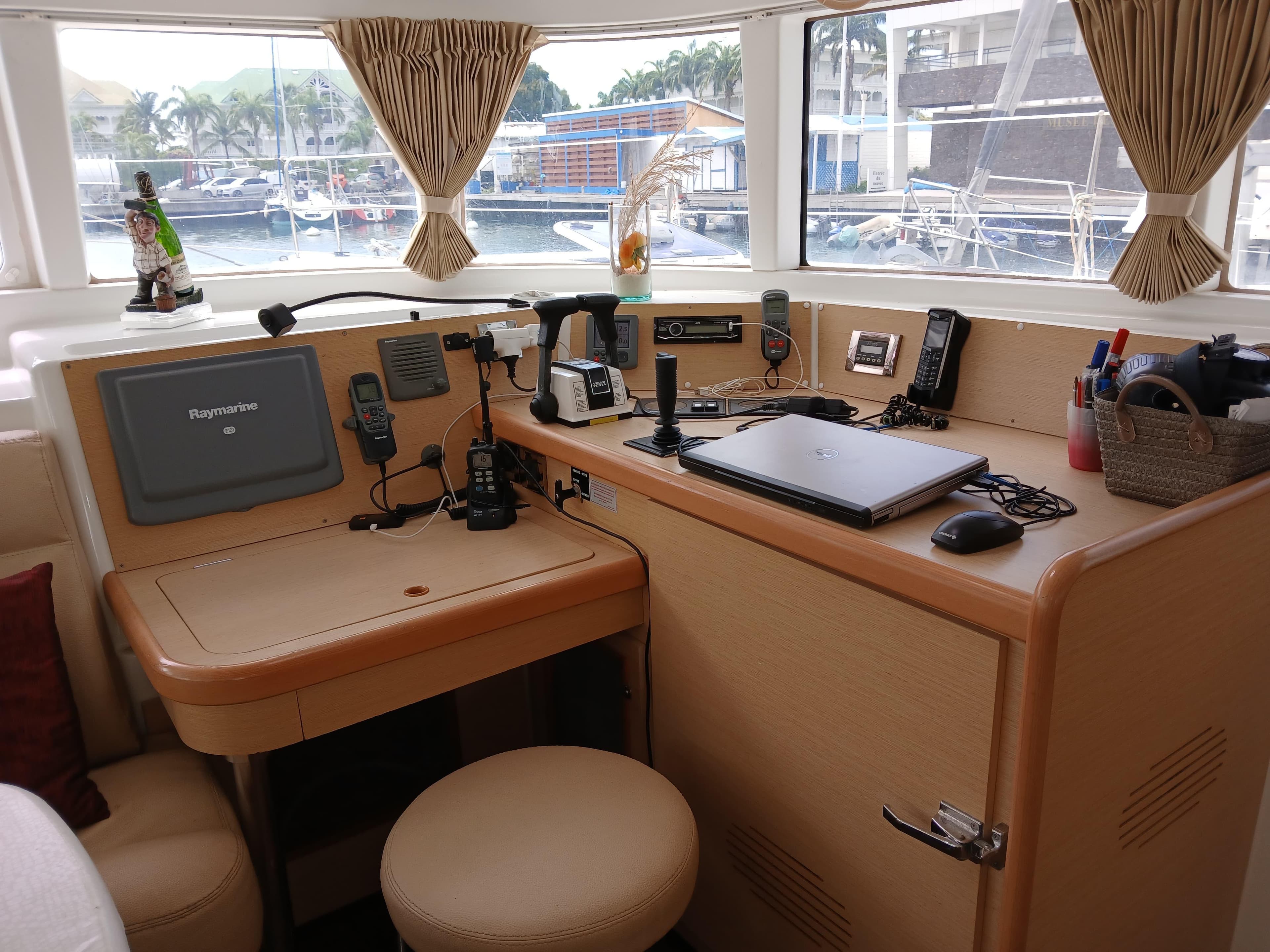 Interior of 2009 Lagoon 440 yacht with navigation equipment and cozy seating area.