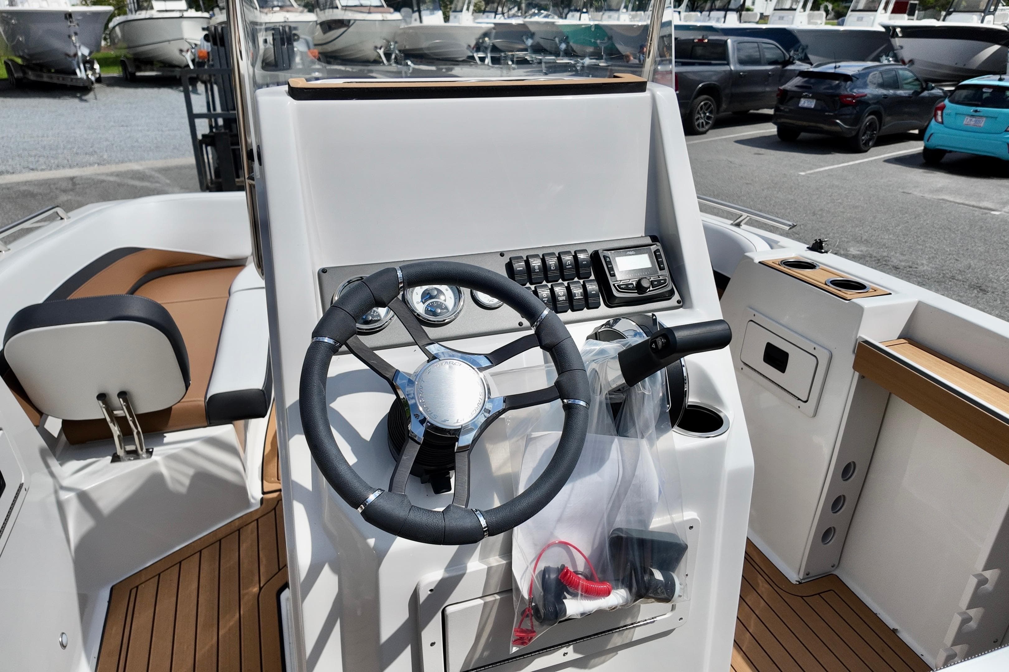 2026 Starcraft SVX 191 OB CC boat cockpit with steering wheel and control panel.