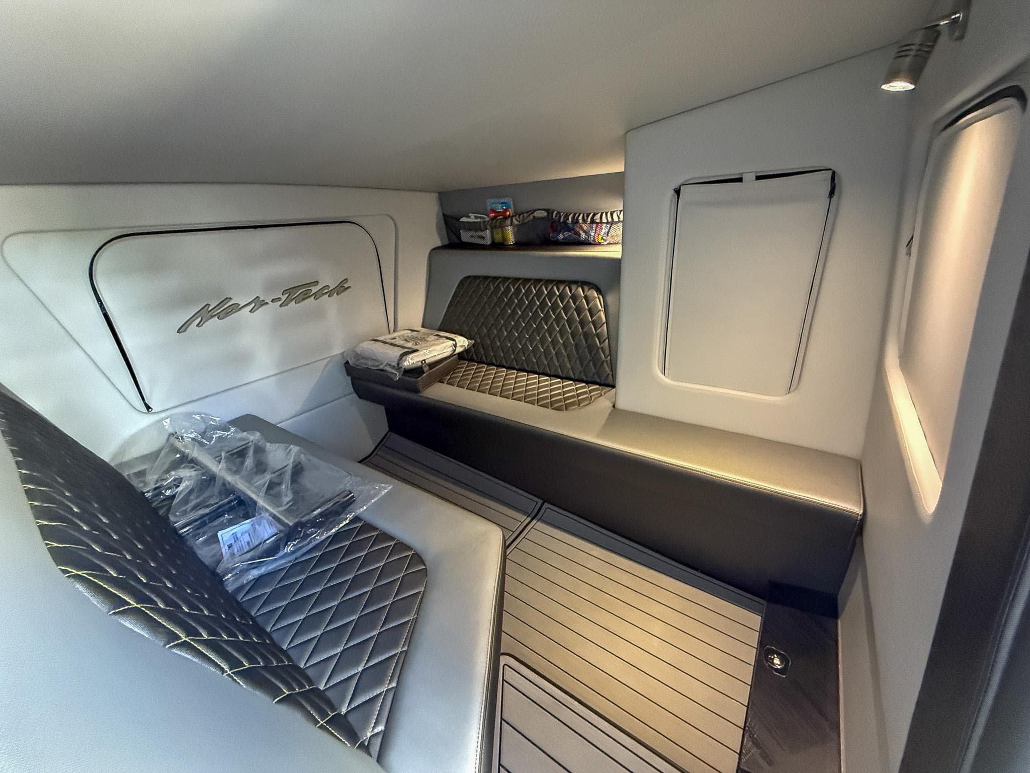 Interior of 2017 Nor-Tech 3900 Super-VEE boat with quilted seating and modern design.