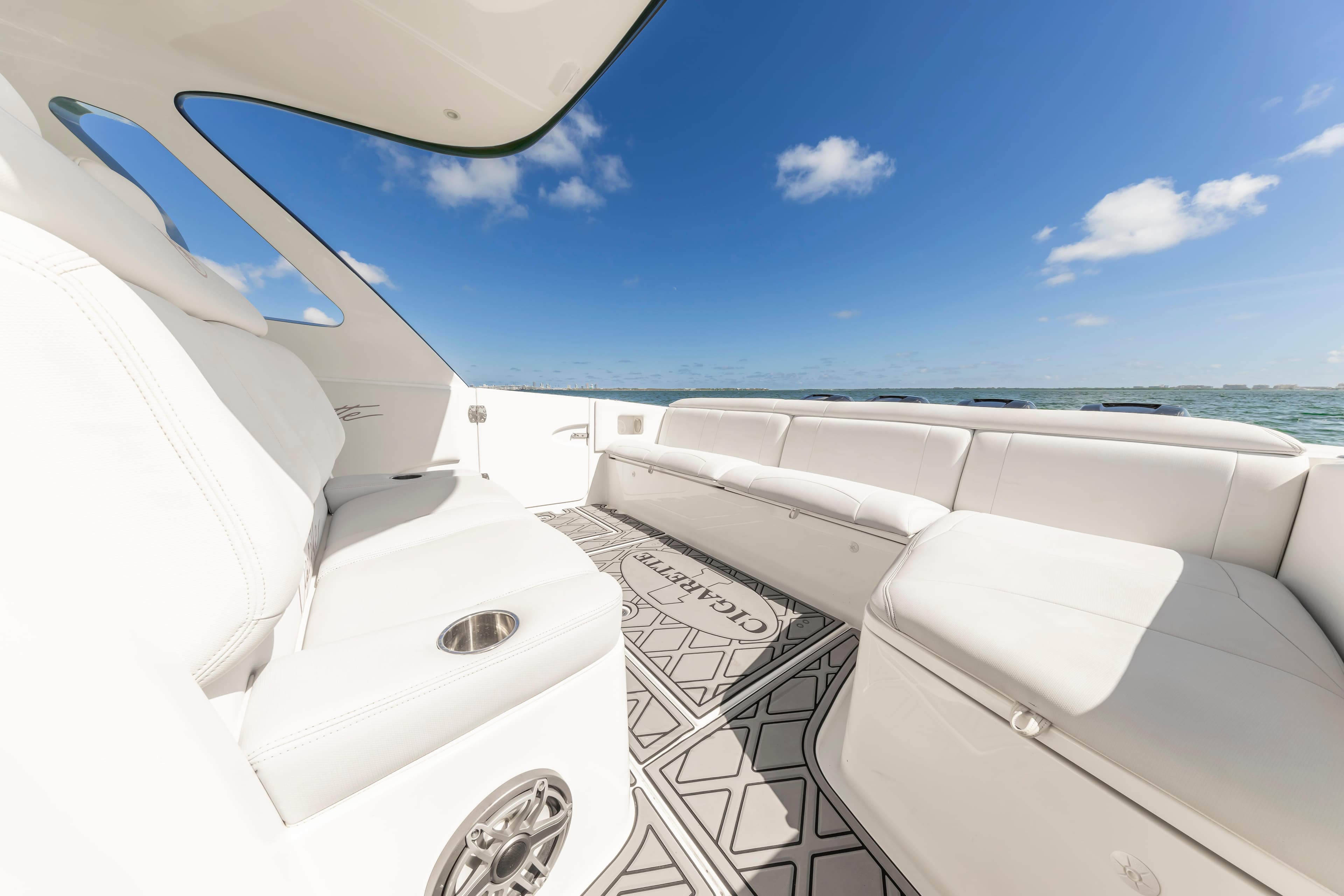 Luxurious interior of 2016 Cigarette 41 GTR boat with white seating and ocean view.