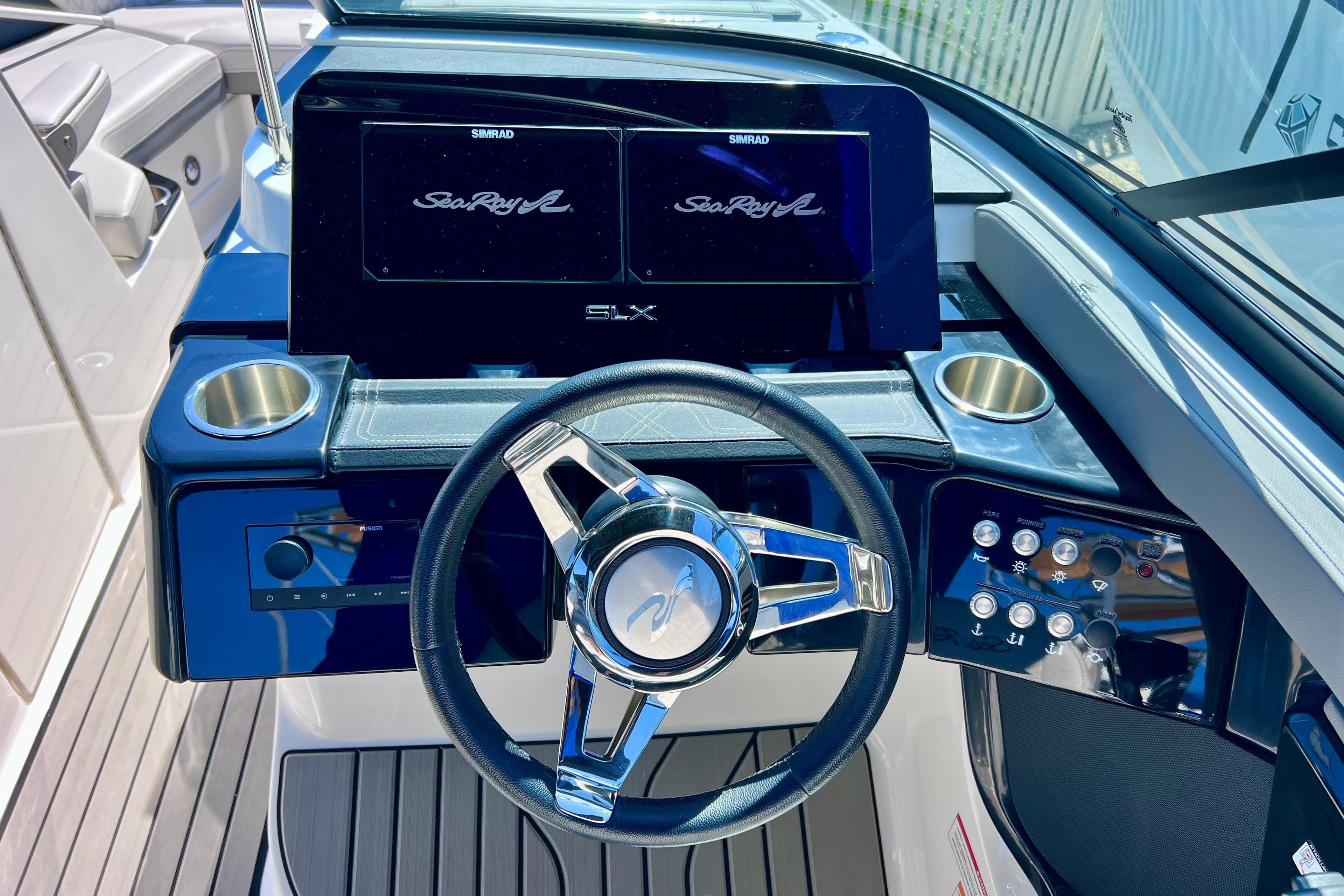2024 Sea Ray SLX 260 Outboard dashboard with steering wheel and control panel.