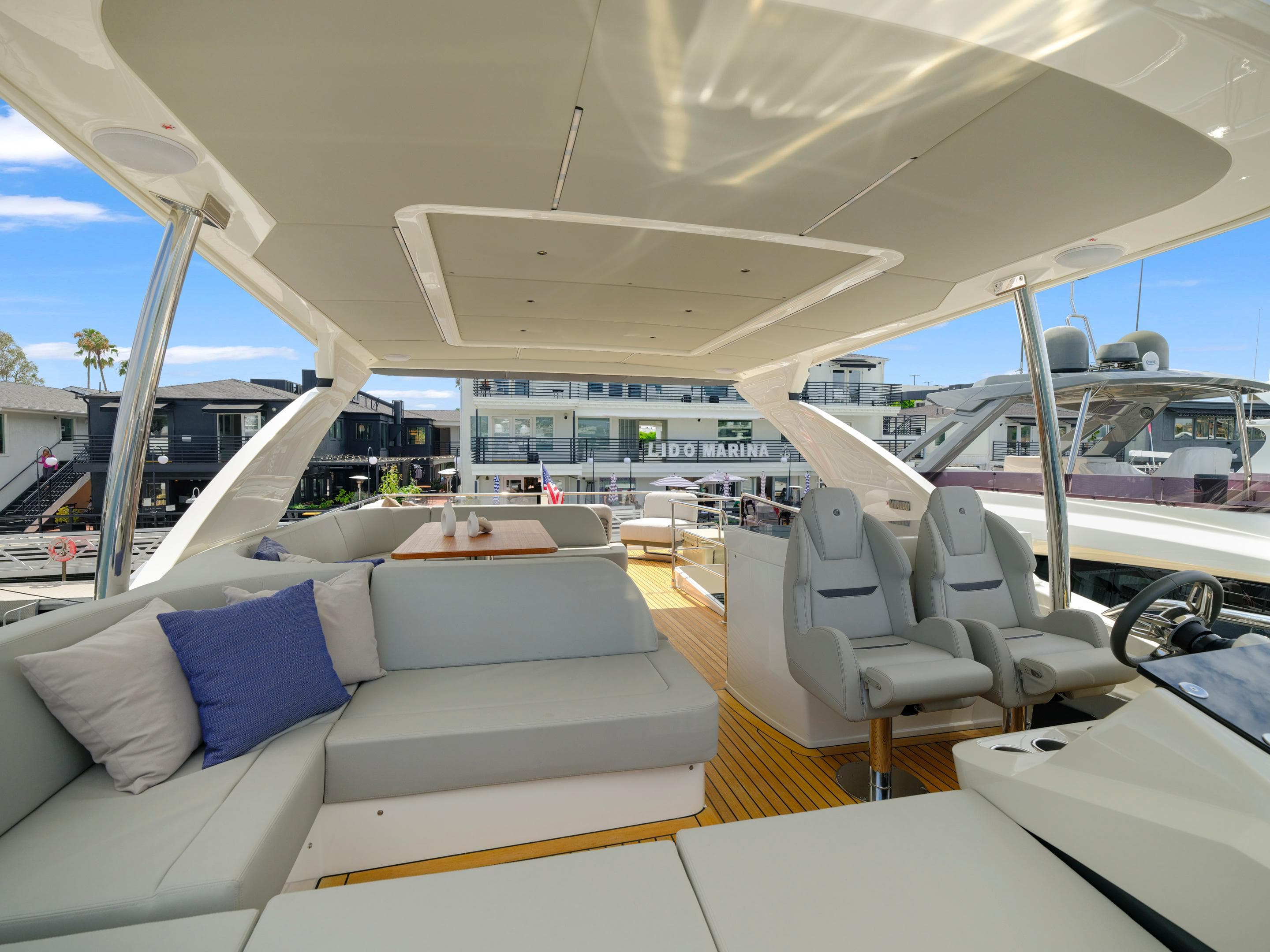 Luxurious interior of the 2024 Absolute 60 Fly yacht with modern seating and helm station.