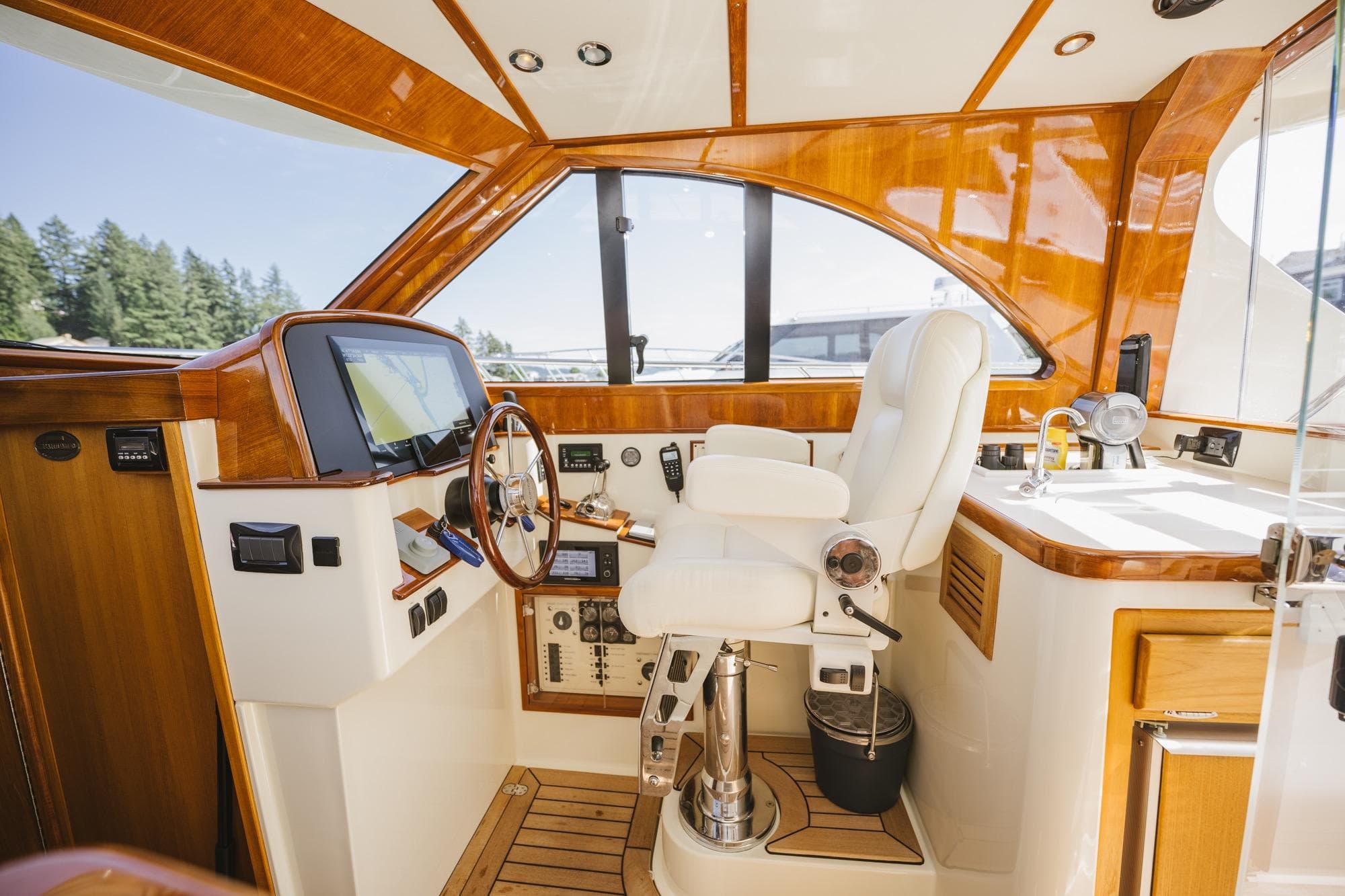 Luxurious 2010 San Juan SJ40FB IPS yacht interior with polished wood and modern controls.