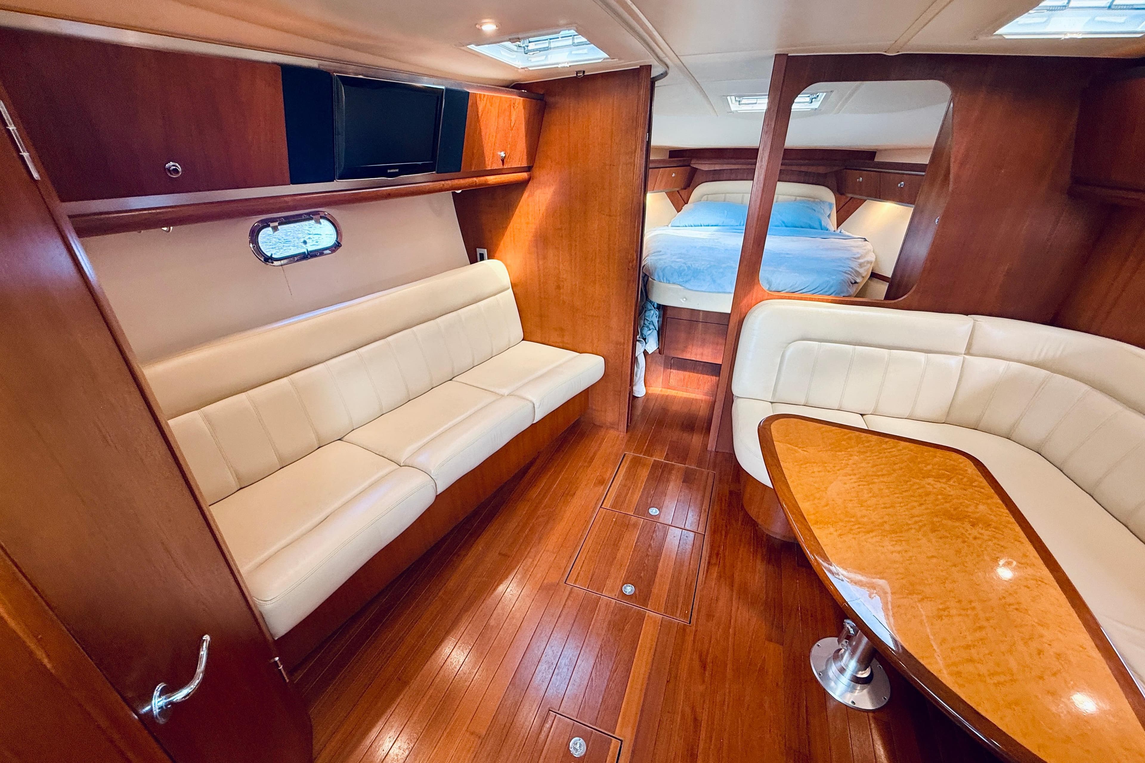Luxurious 2005 Tiara Yachts 3600 Sovran interior with wood finish and comfortable seating.