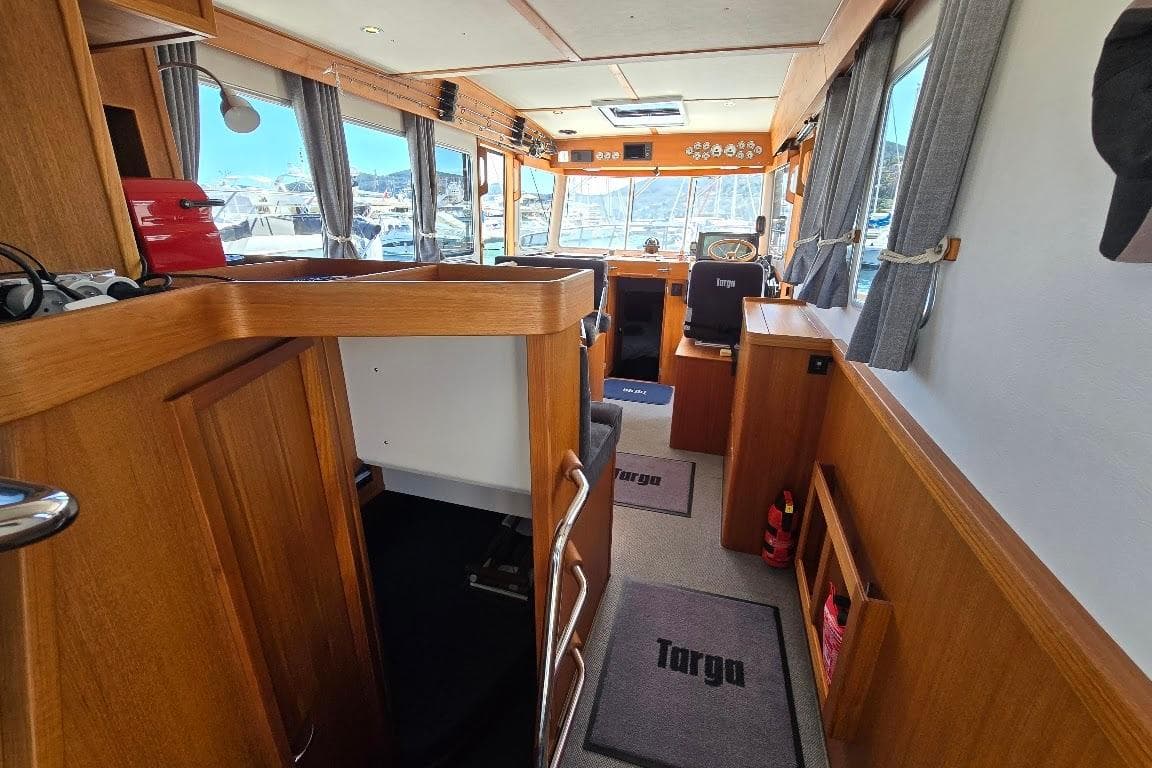 Interior of a 2022 Targa 37 boat, featuring wooden finishes and nautical decor.