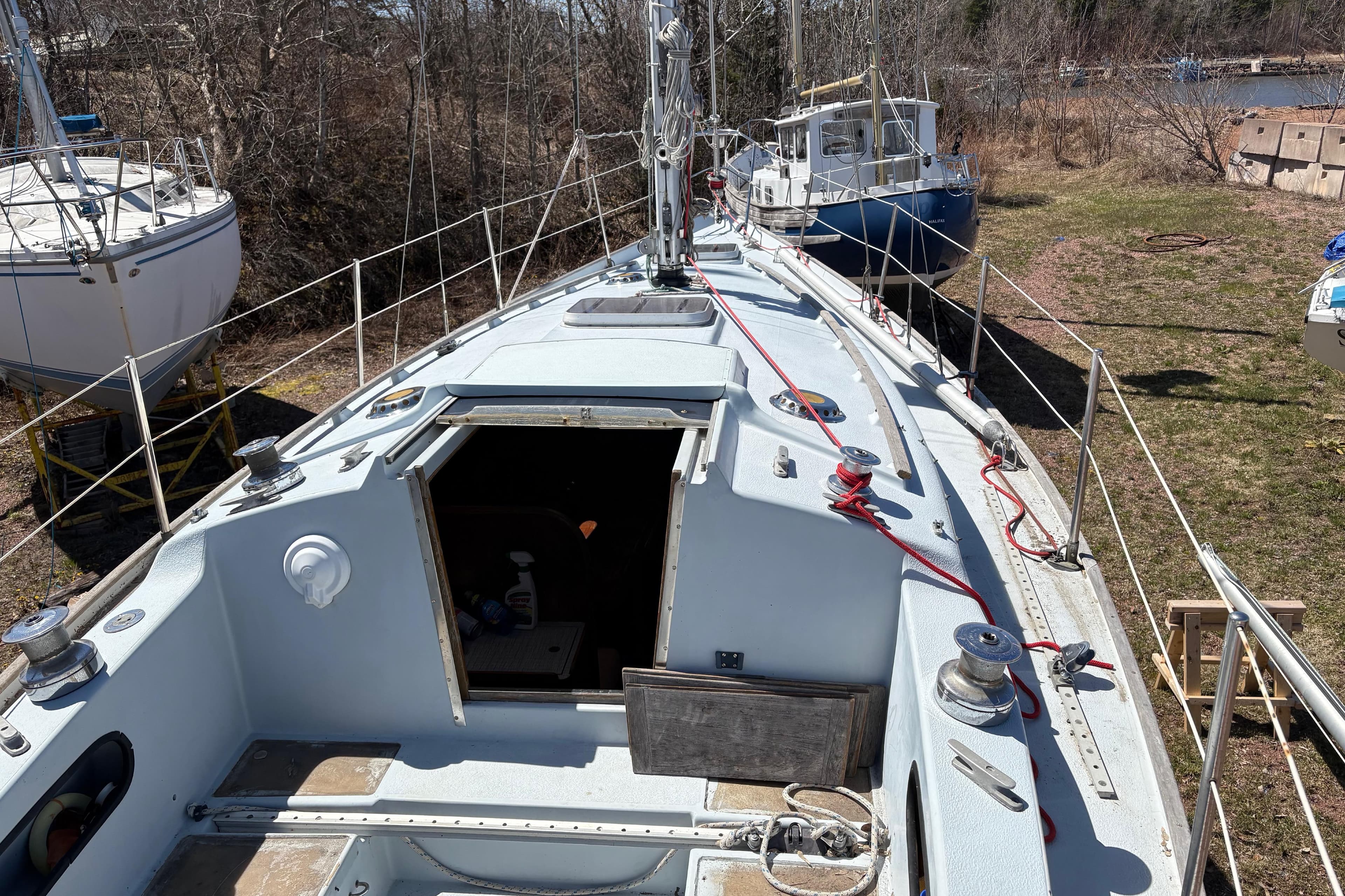 1979 Contessa 32 sailboat on land, showing deck and open cabin hatch.