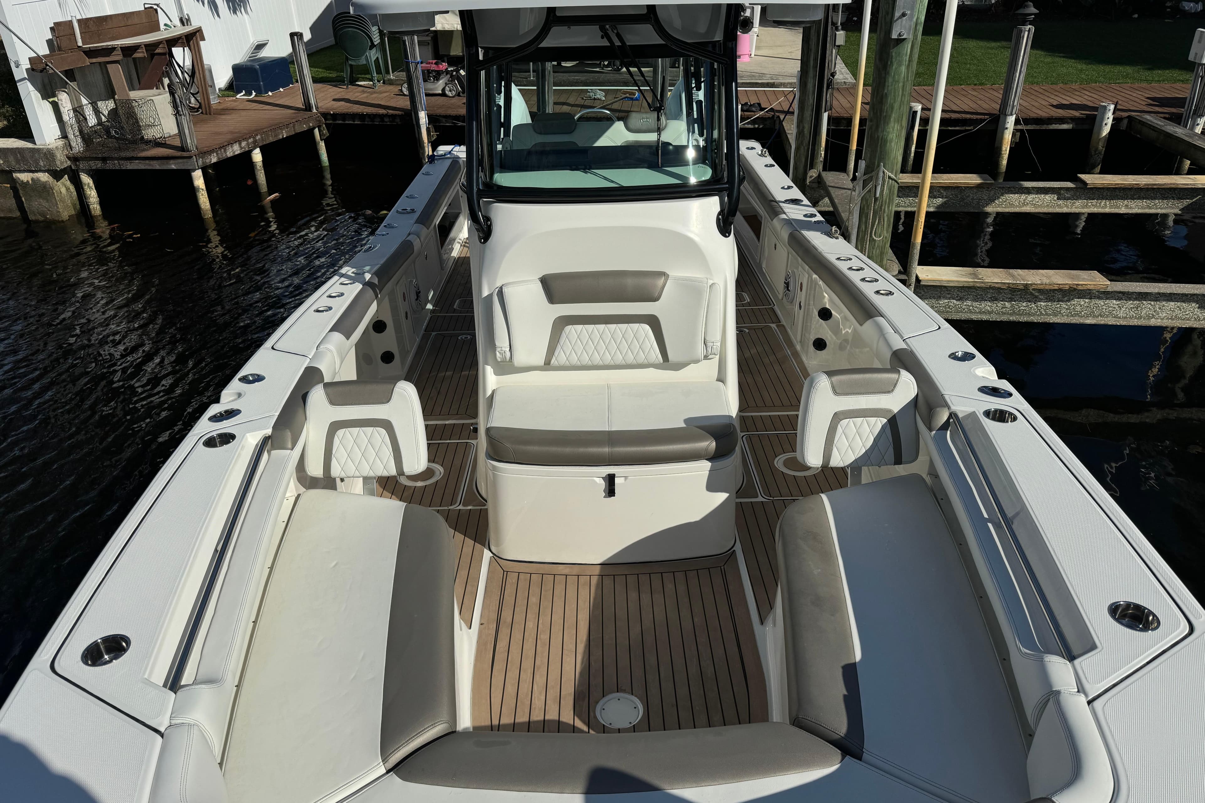 2023 World Cat 325 CC boat interior with seating and wood flooring.