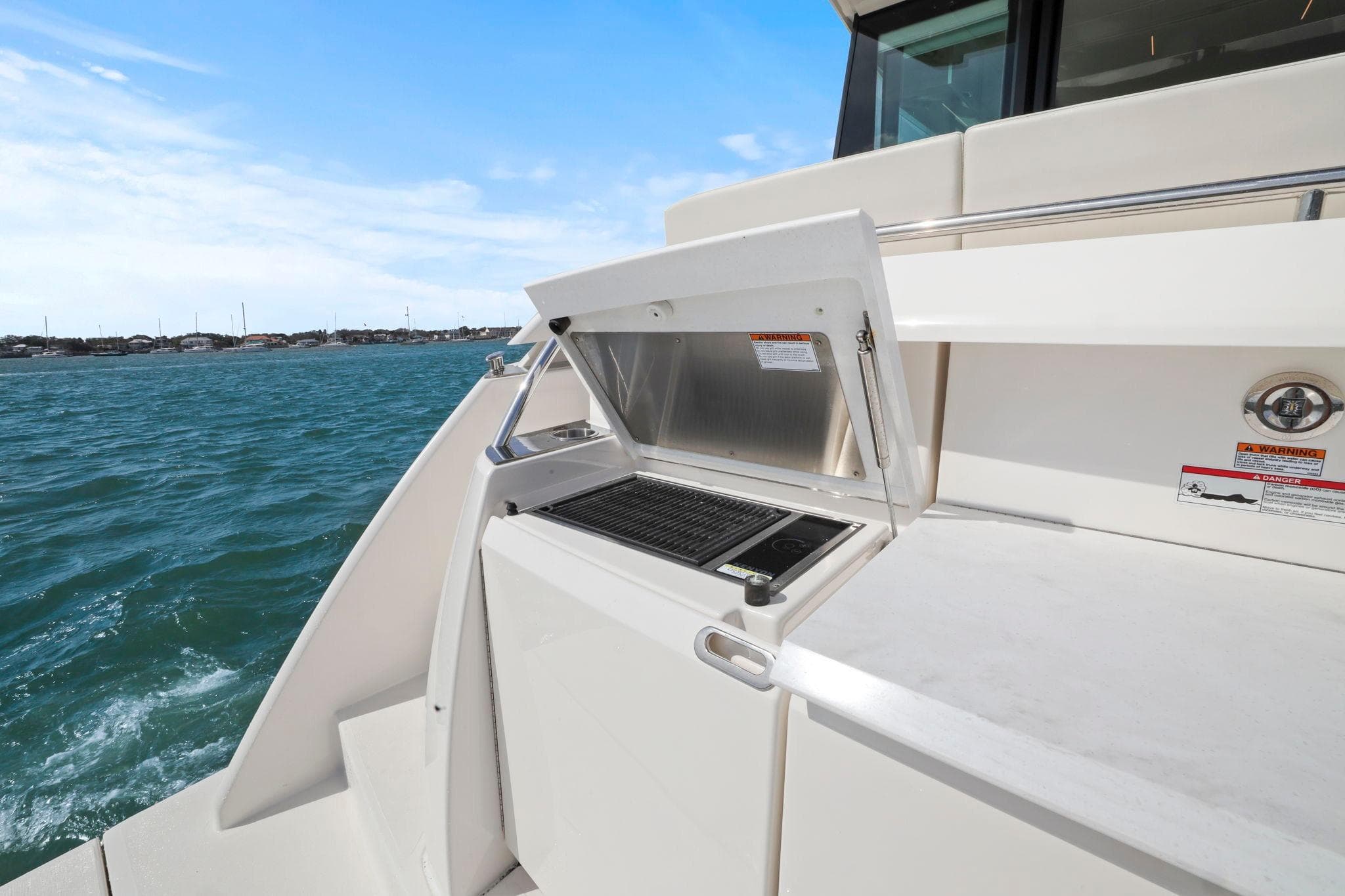 2023 Tiara Yachts C49 Coupe outdoor grill on deck with ocean view.