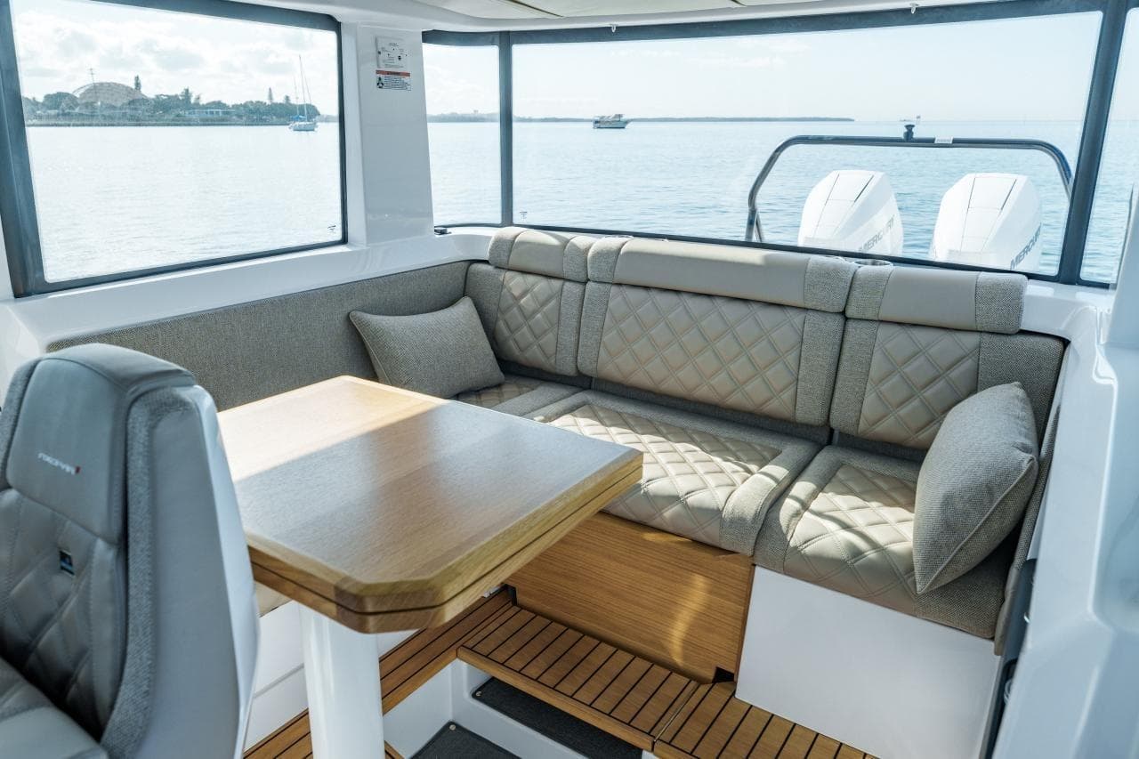 Luxurious interior of 2026 Axopar 37 XC Cross Cabin with plush seating and scenic water view.