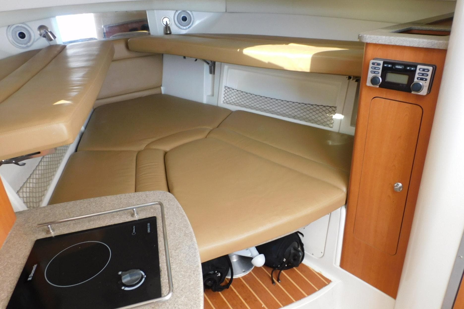 Interior of 2012 Sailfish 30-06 Express boat with cozy seating and compact kitchen area.