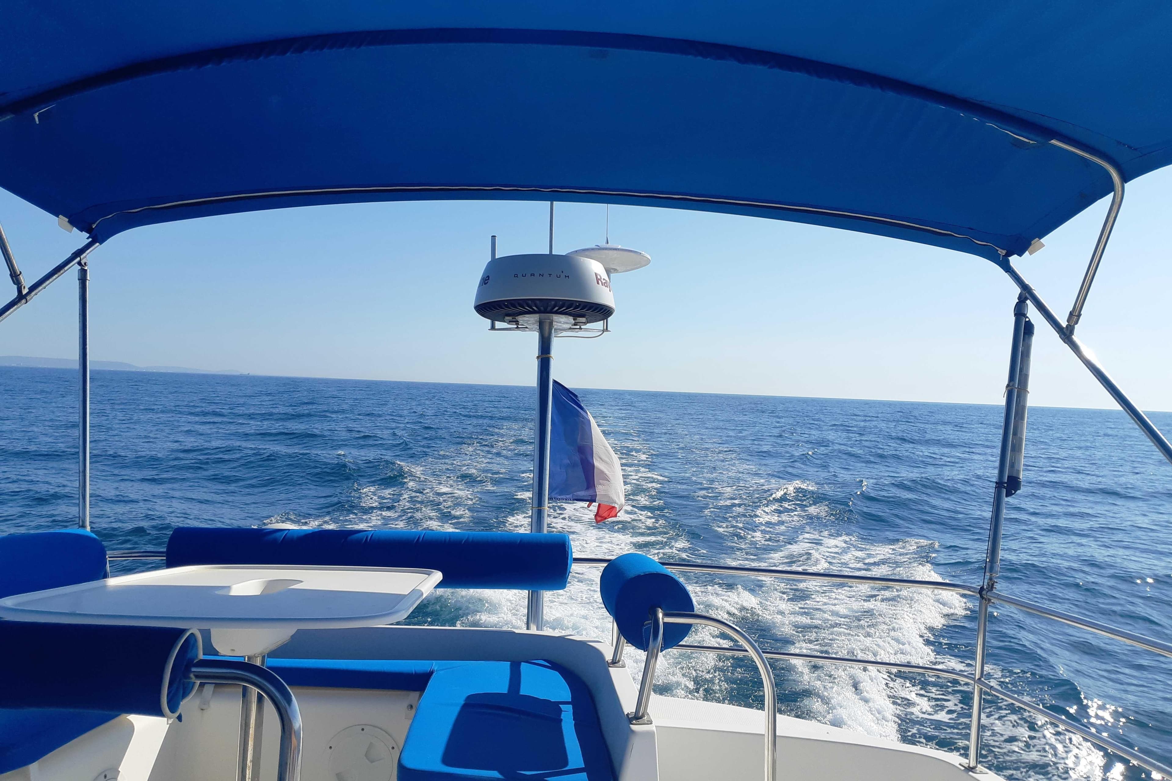 2004 Fountaine Pajot Maryland 37 cruising on open sea under blue canopy.