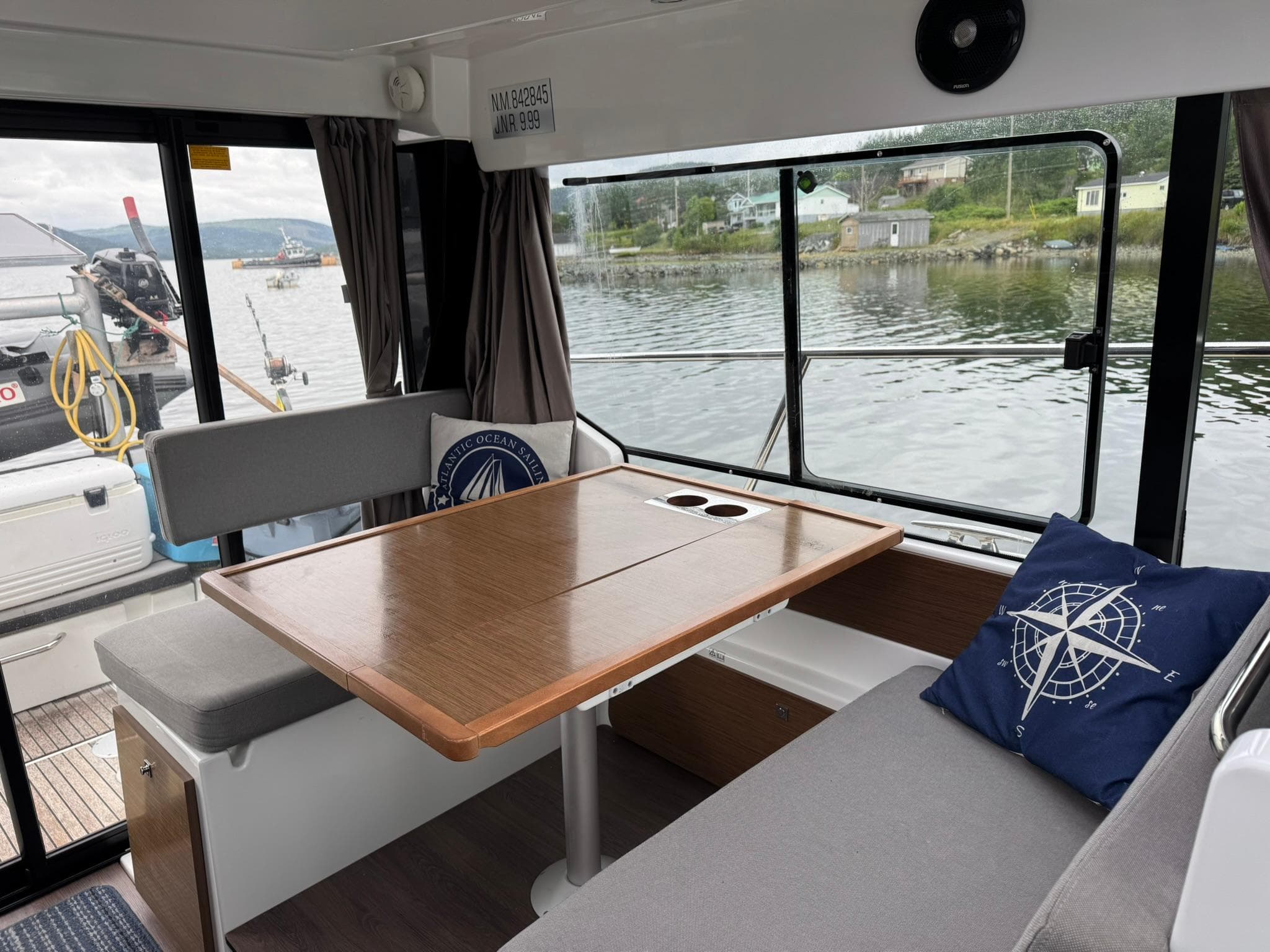 Interior of 2020 Jeanneau NC 1095 boat with dining area and waterfront view.