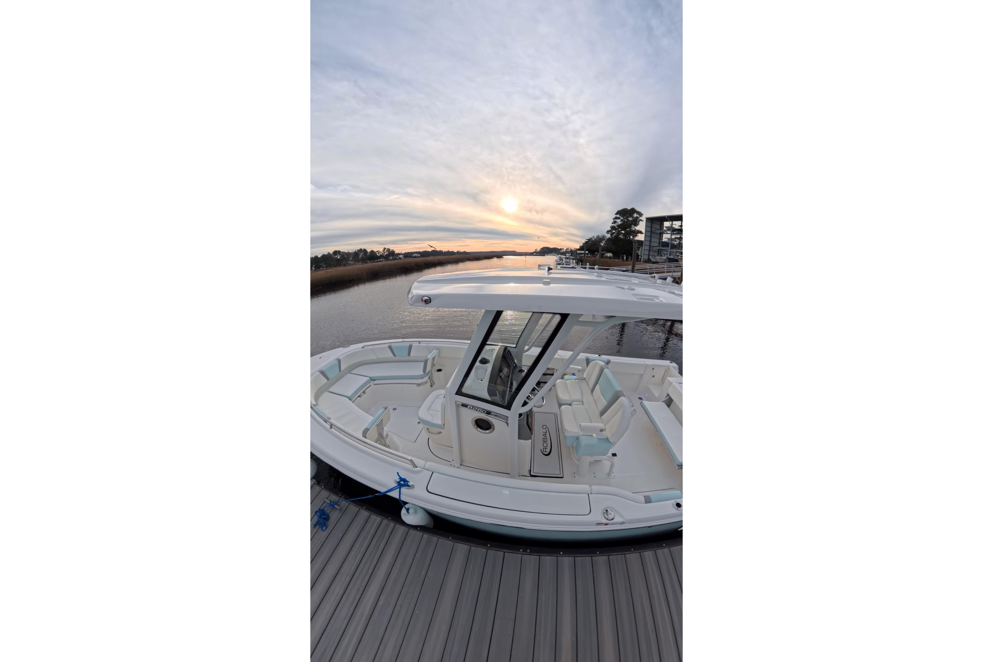 2025 Robalo R250 Center Console boat docked at sunset, showcasing sleek design.