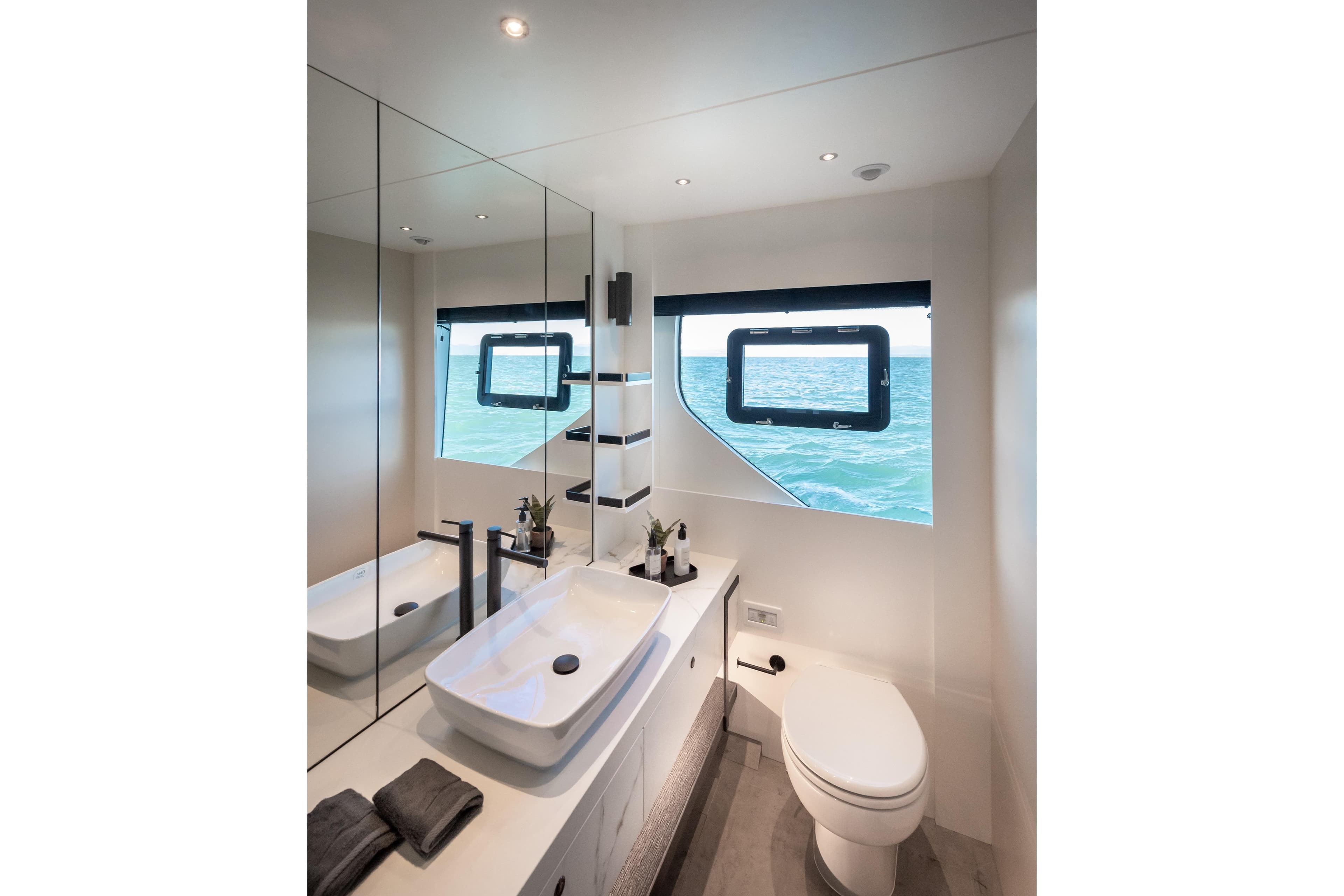 Luxurious bathroom interior of 2025 Numarine 22XP yacht with ocean view.