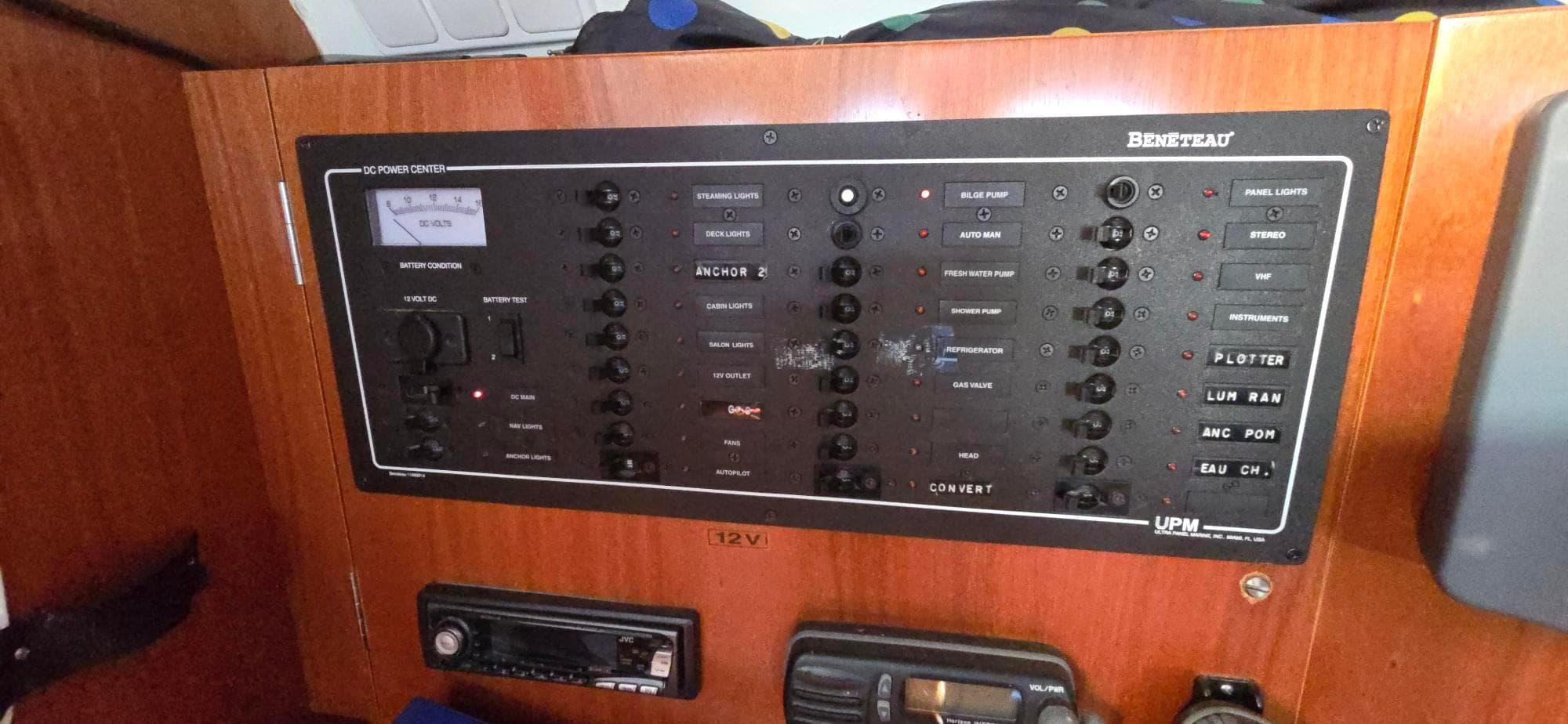 Control panel of a 2001 Beneteau Oceanis 473 sailboat, featuring various switches and indicators.