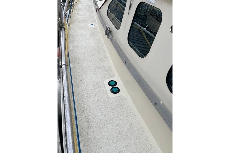Deck view of 2020 Bruce Roberts 46 Pilothouse yacht with windows and railing.