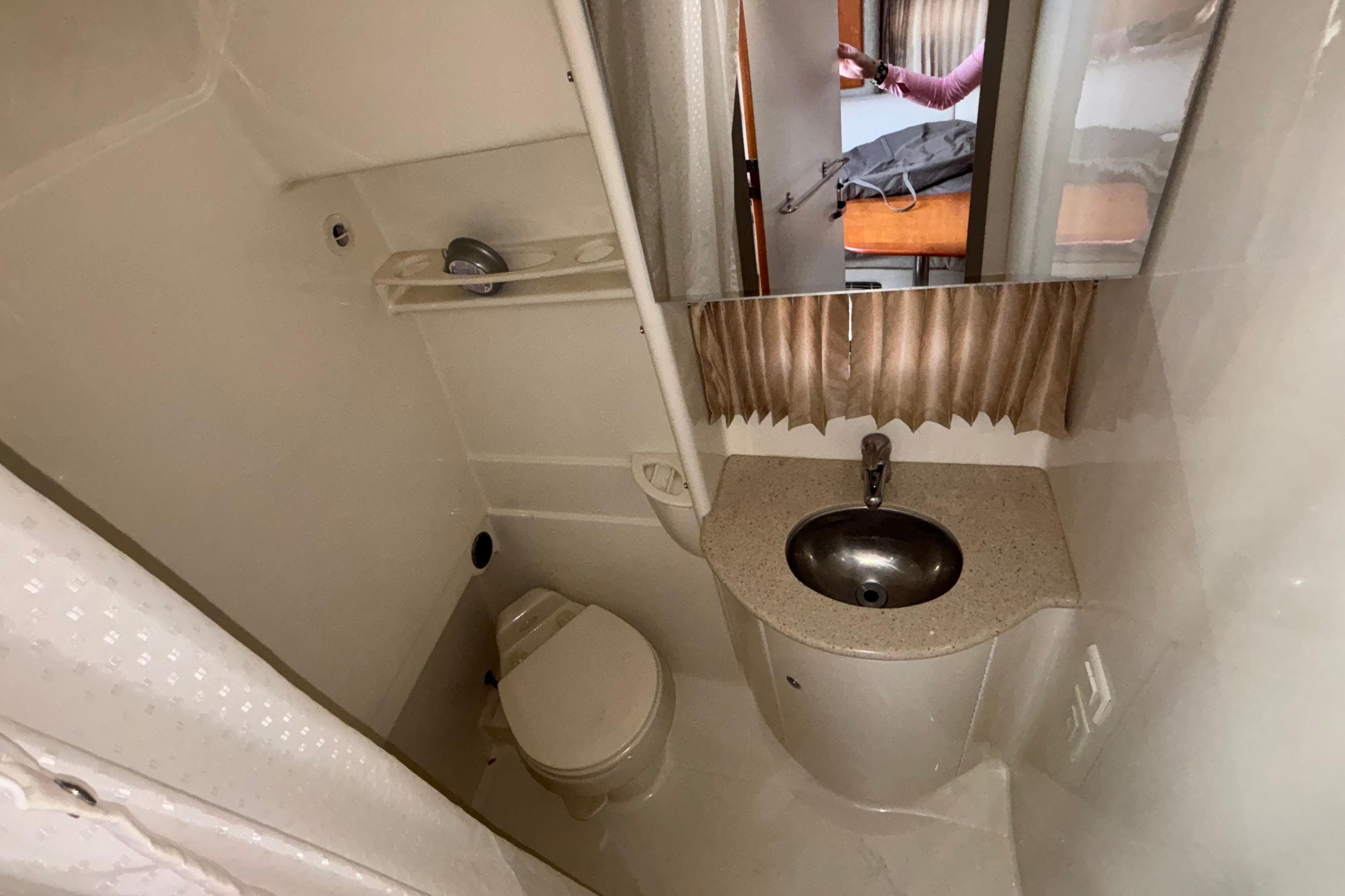 2005 Formula 31 Performance Cruiser bathroom with sink, toilet, and mirror.