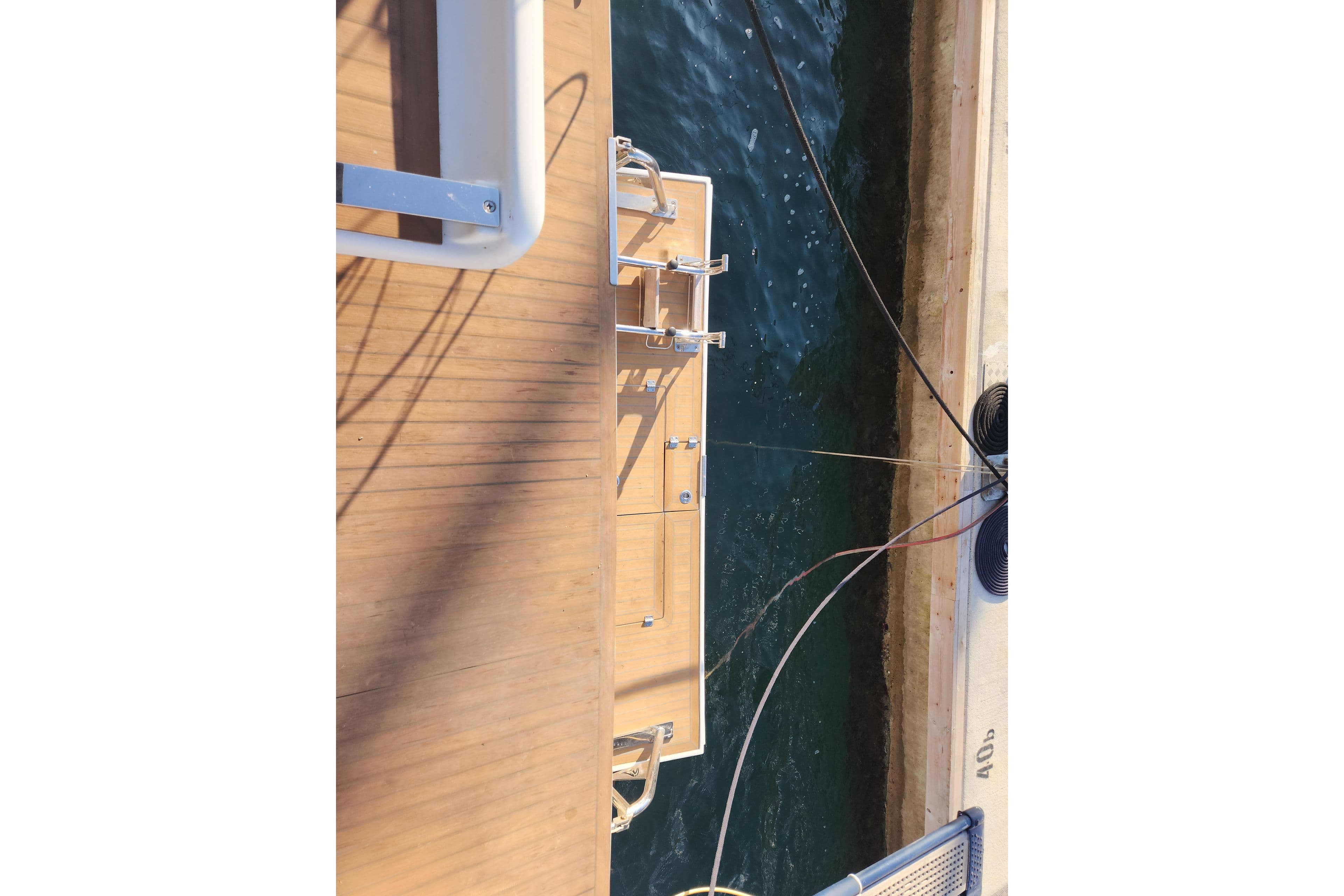 Deck view of a 2015 Hanse 575 yacht docked at a marina.