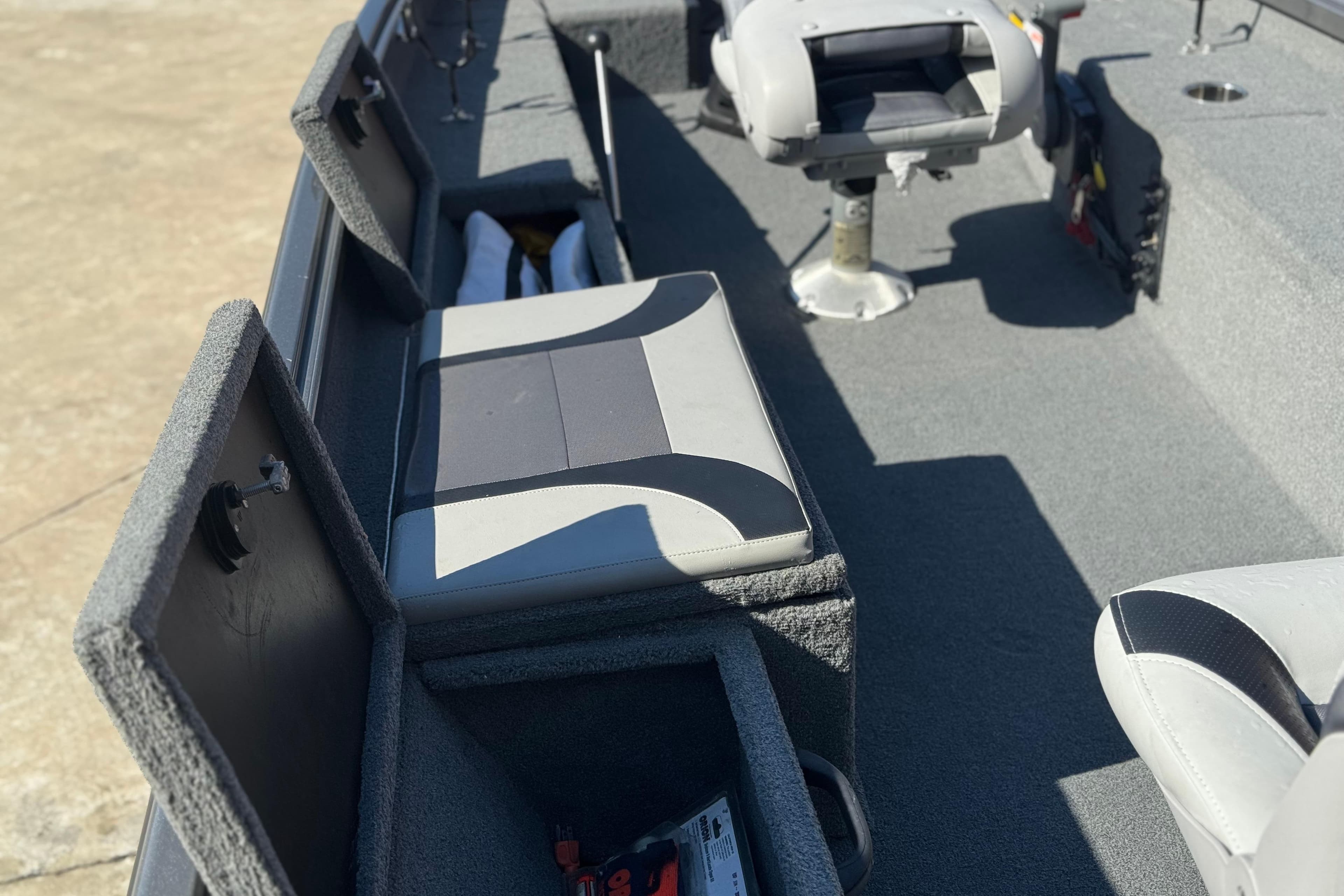 2018 Alumacraft Crappie Deluxe boat interior with storage compartments and seating.