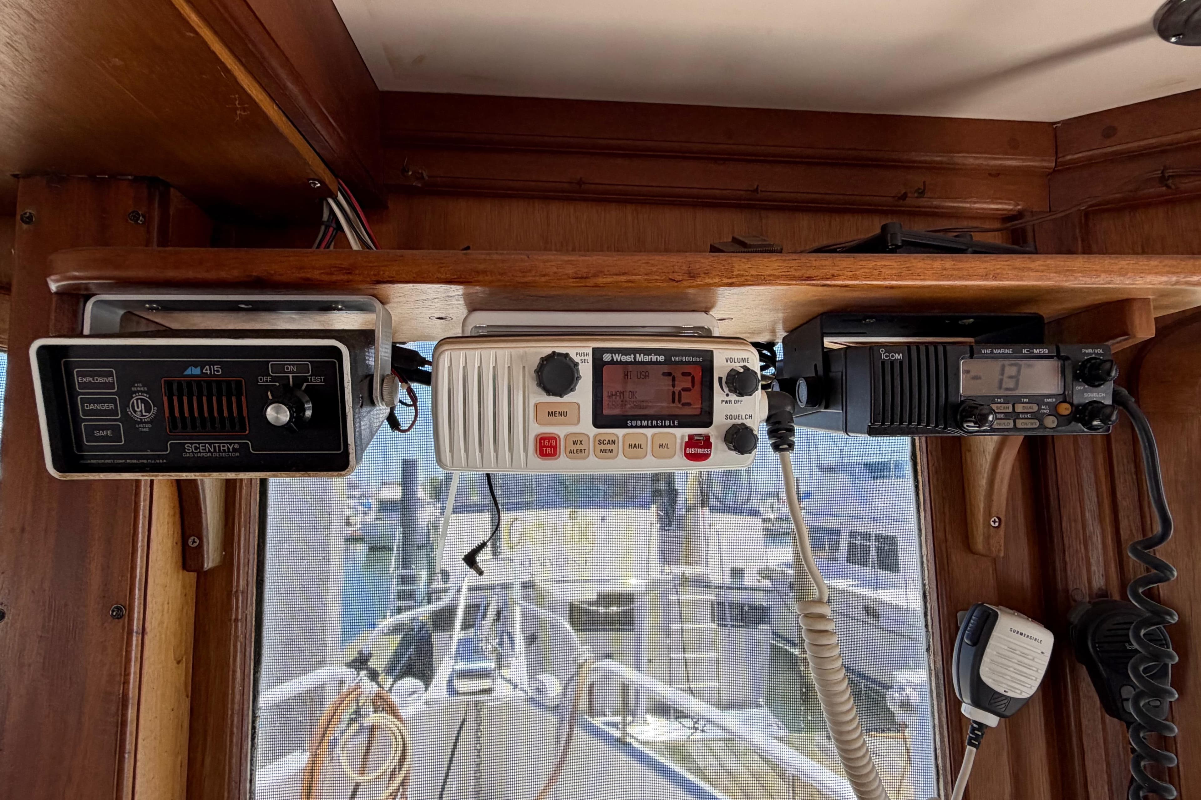 1985 Gozzard PILGRIM boat interior with marine radio equipment and wooden paneling.