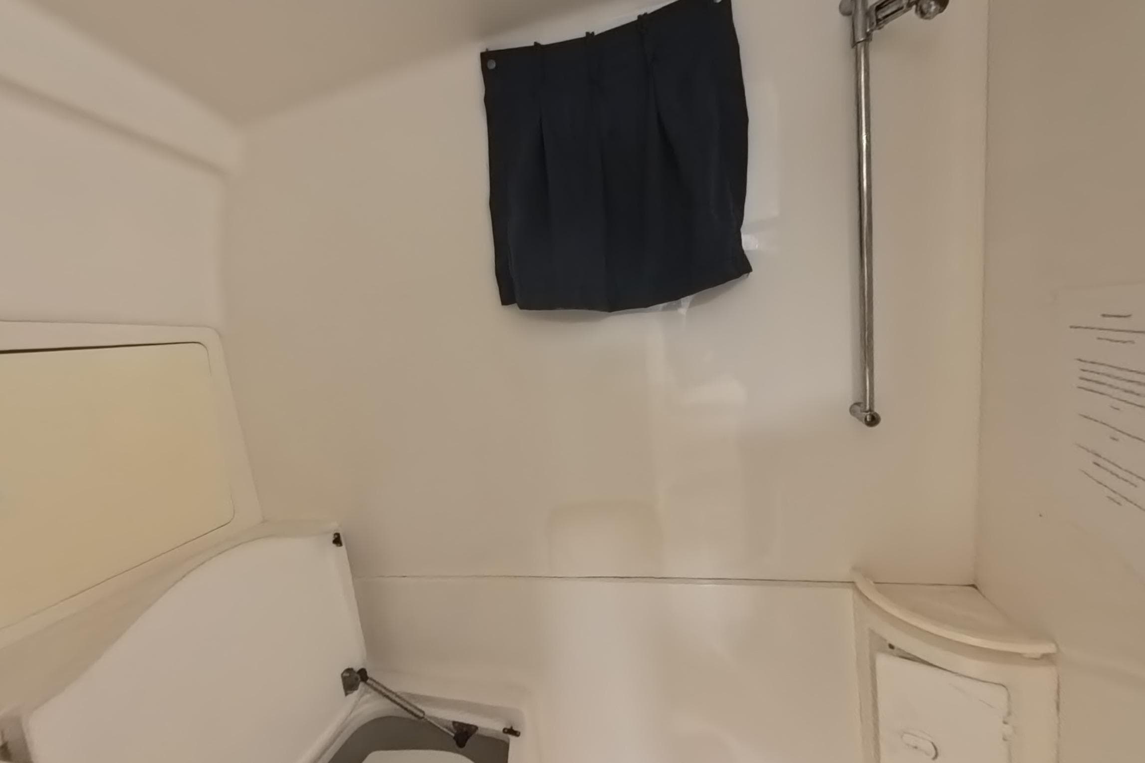 Interior of a 2005 Intrepid 348 Walkaround boat, featuring a compact cabin space.