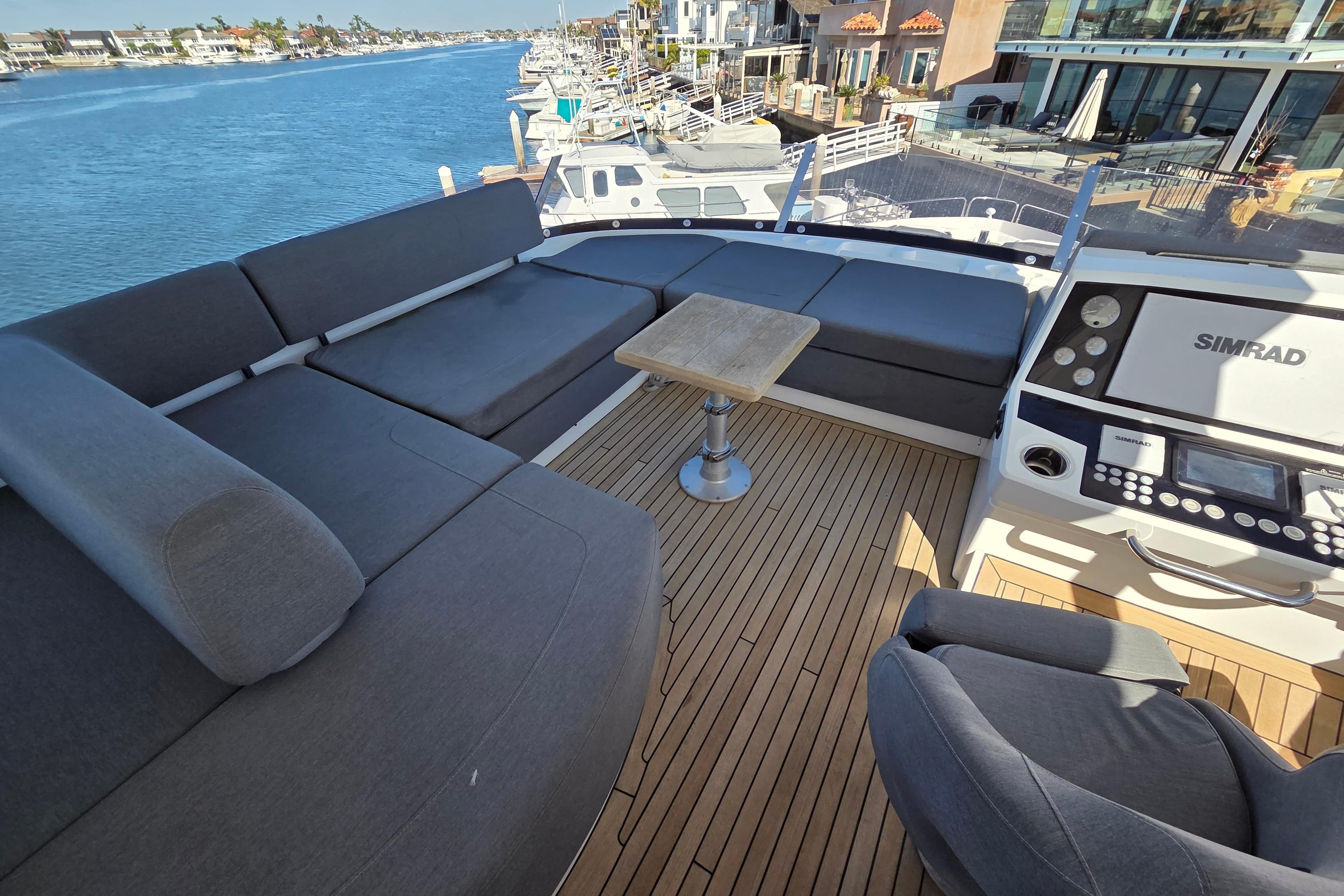 Luxurious 2018 Sunseeker 76 Yacht deck with seating, table, and navigation equipment.
