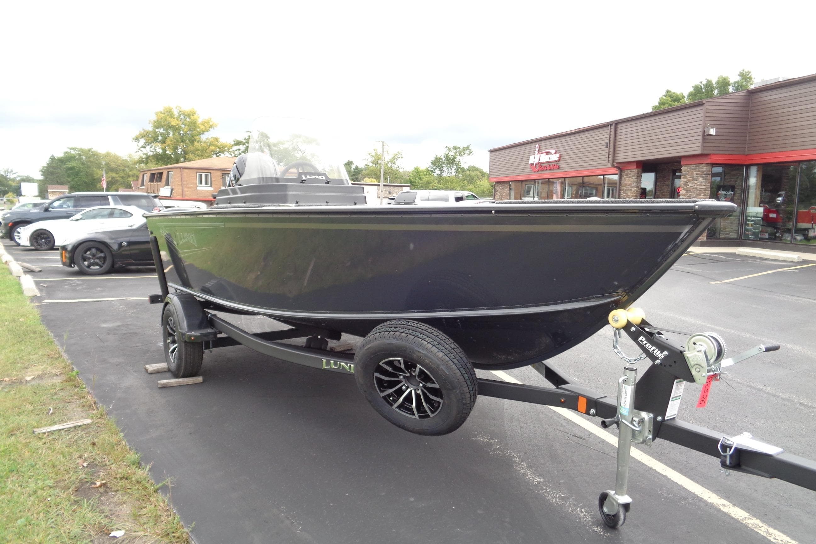 2026 Lund 1675 Adventure SS boat on trailer in parking lot.