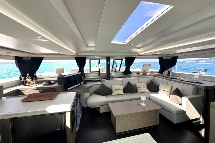Luxurious interior of 2023 Fountaine Pajot Astrea 42 Catamaran with modern furnishings and ocean view.