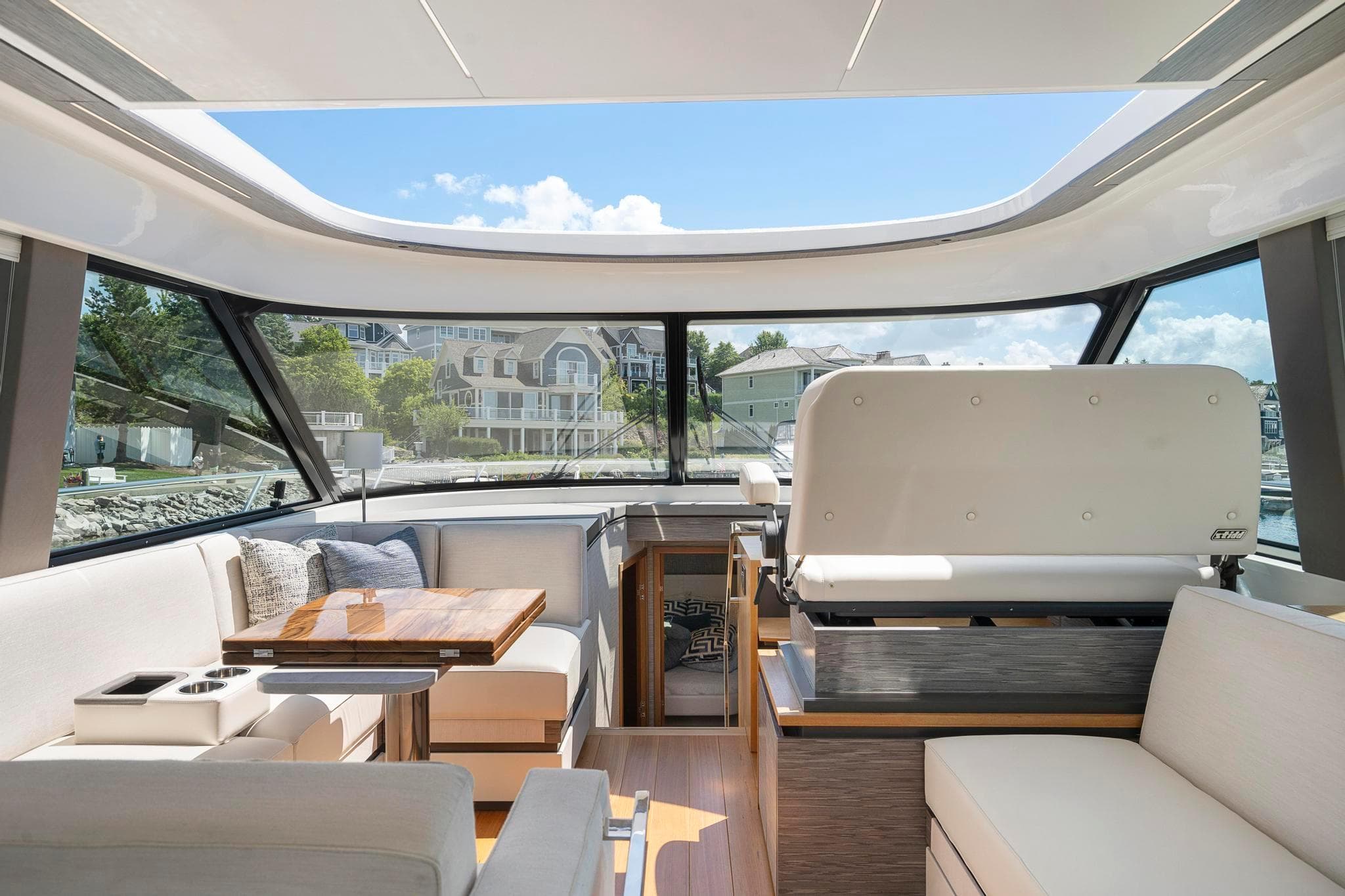 Interior of 2022 Tiara Yachts C49 Coupe, featuring luxurious seating and panoramic windows.