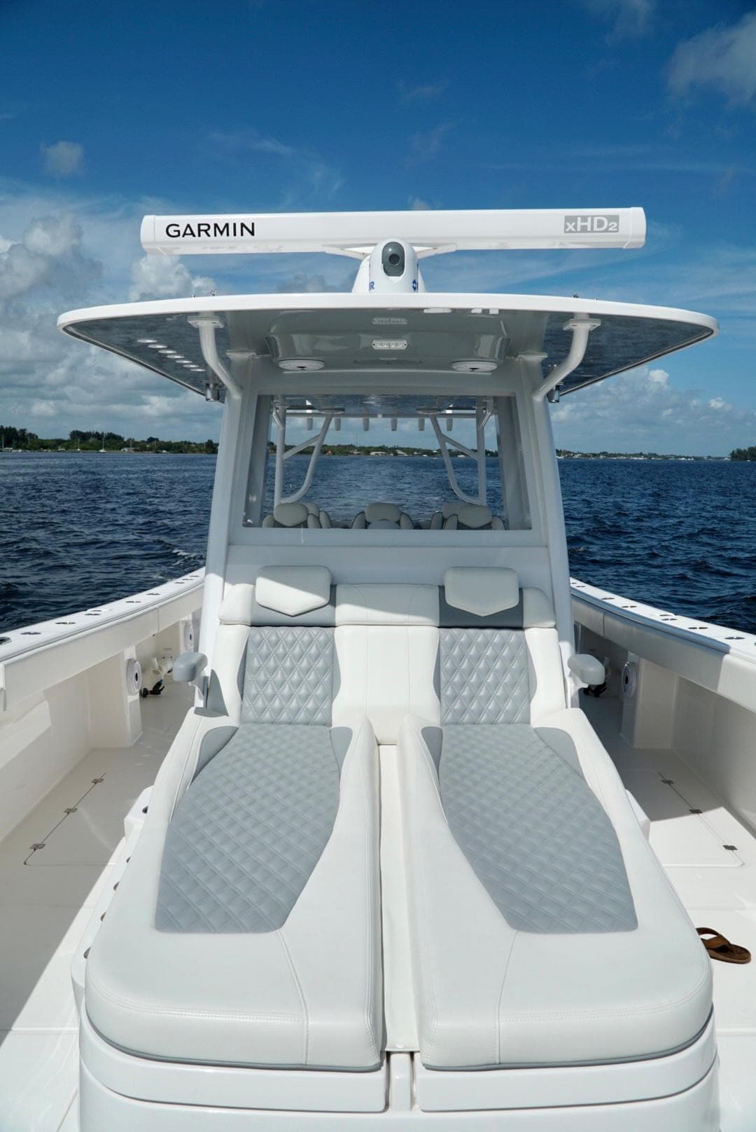 2021 Invincible 46 Catamaran with Garmin radar, luxury seating, and ocean backdrop.