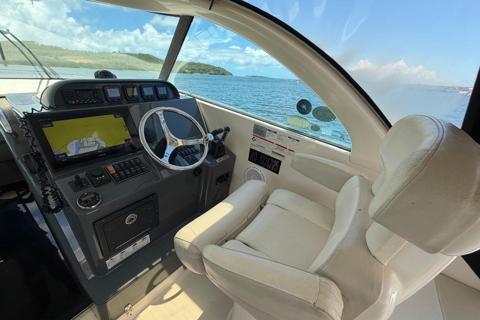Cockpit of 2010 Pursuit OS 345 Offshore boat with steering wheel and navigation system.