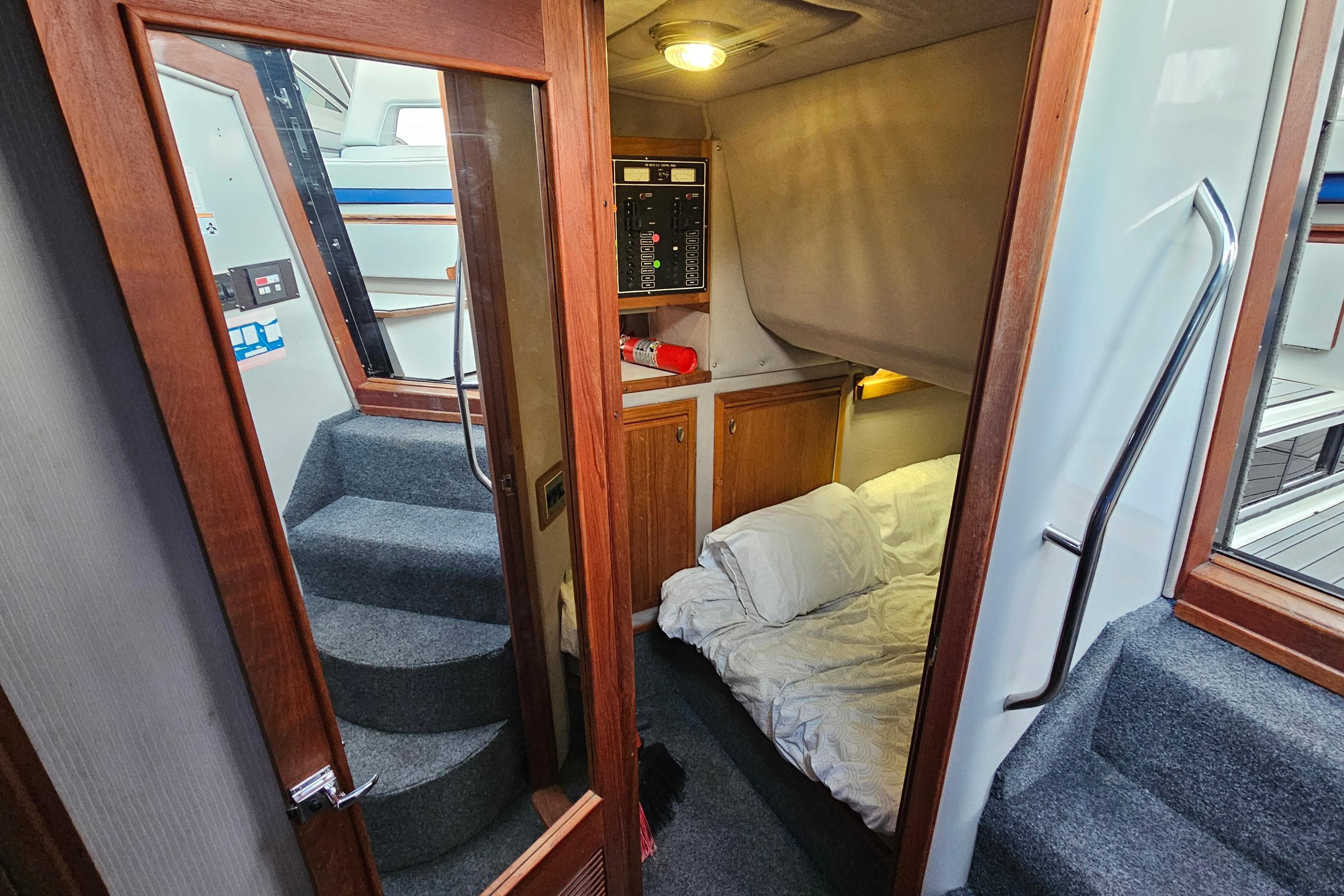 Interior of 1988 Regal Commodore 360 yacht with cozy cabin and carpeted stairs.