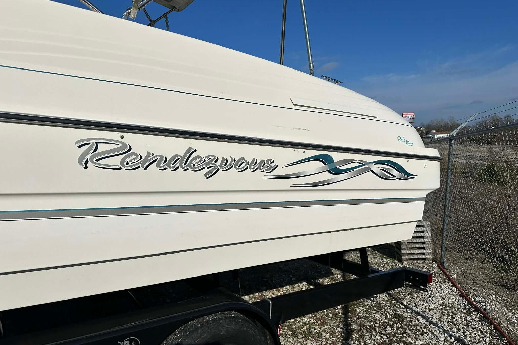 1998 Bayliner 2659 Rendezvous boat on trailer, side view with logo.