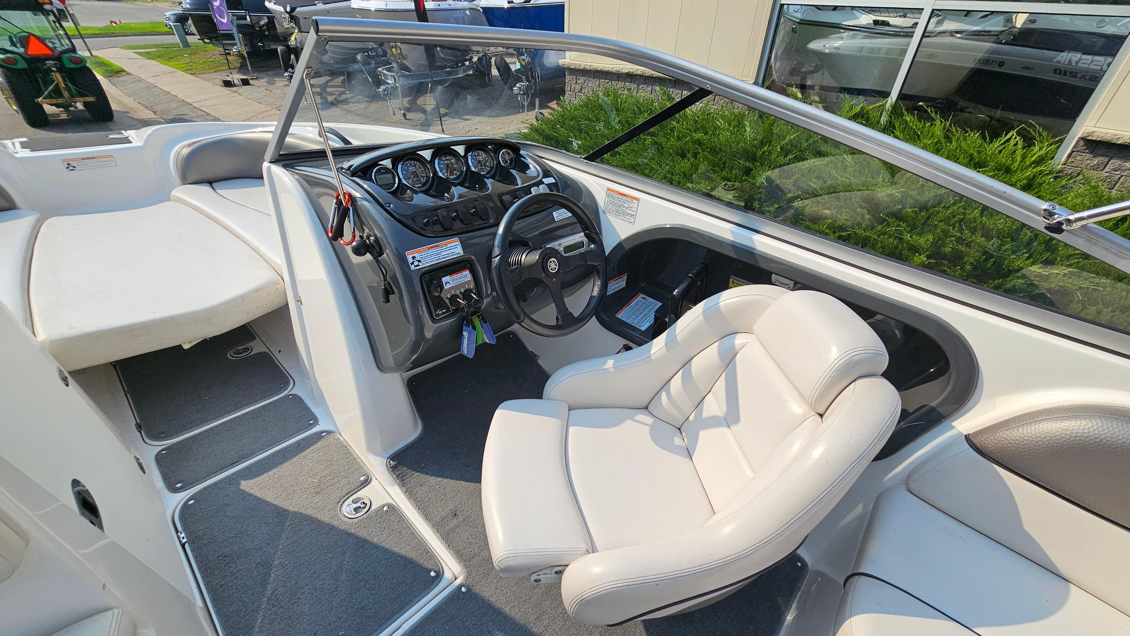 2011 Yamaha SX210 boat interior with steering wheel and seating area.