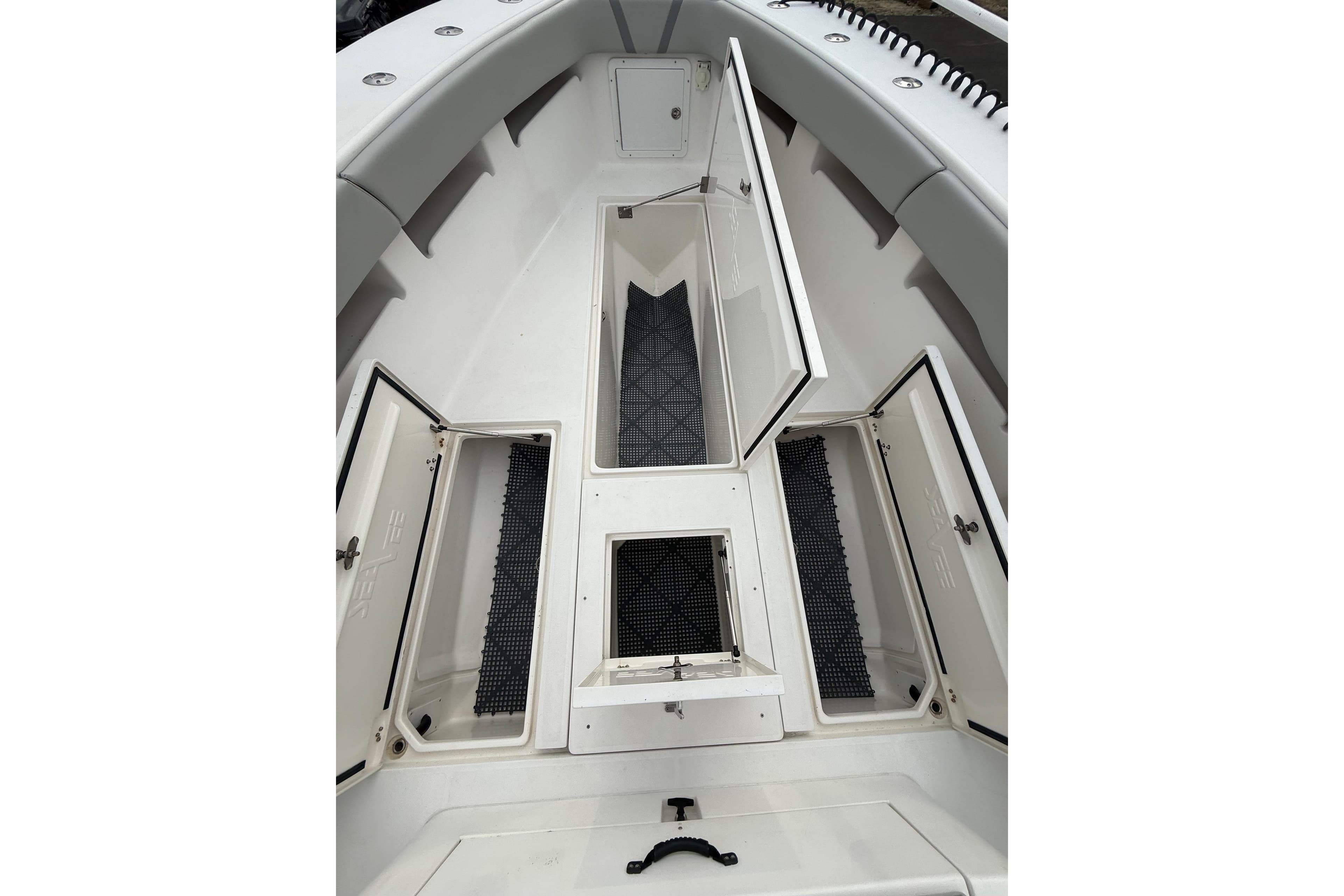 2006 SeaVee 340B boat interior with open storage compartments and clean white deck.