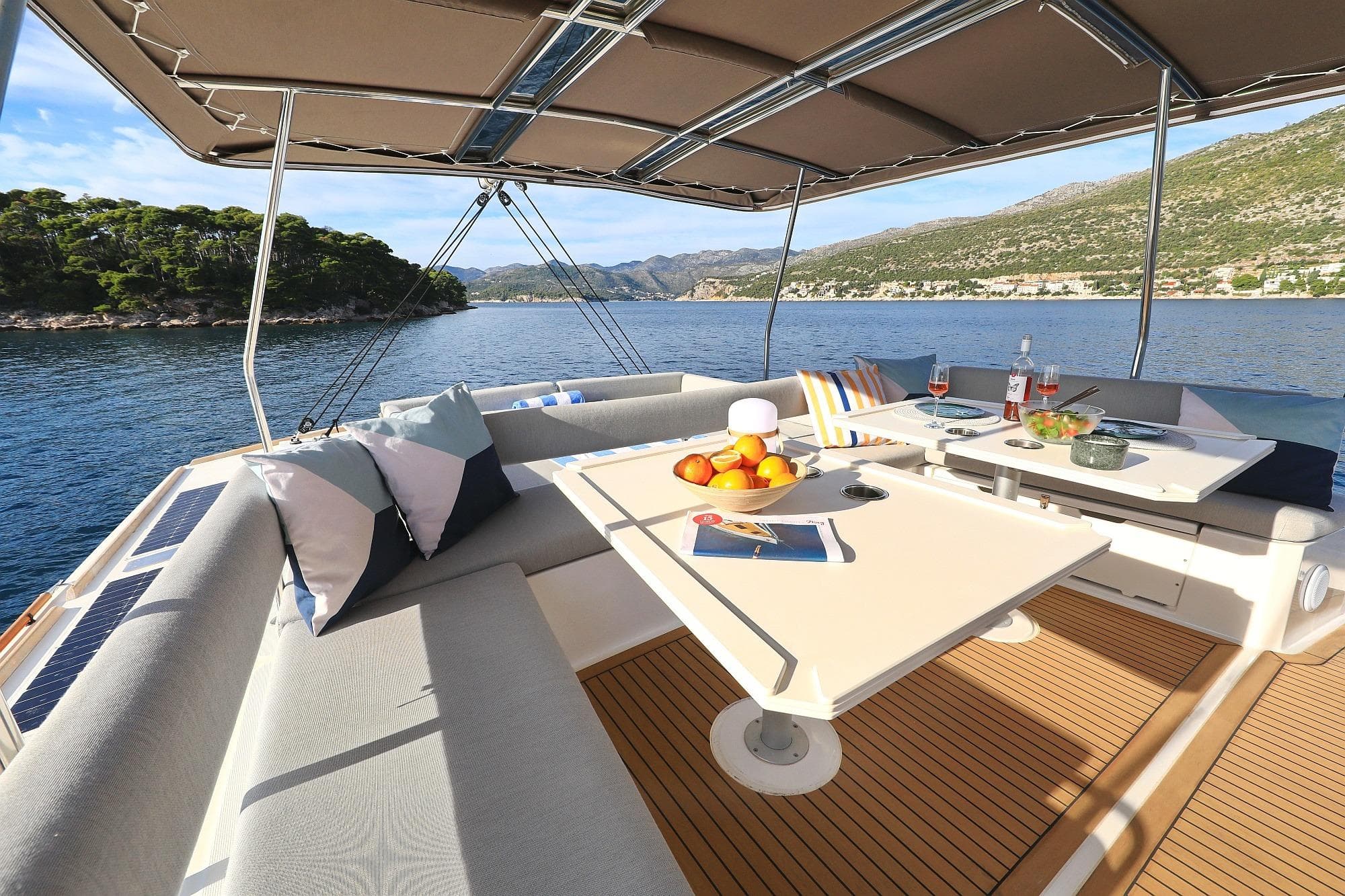 Luxurious Bali 5.4 yacht deck with dining area, scenic ocean view, and comfortable seating.