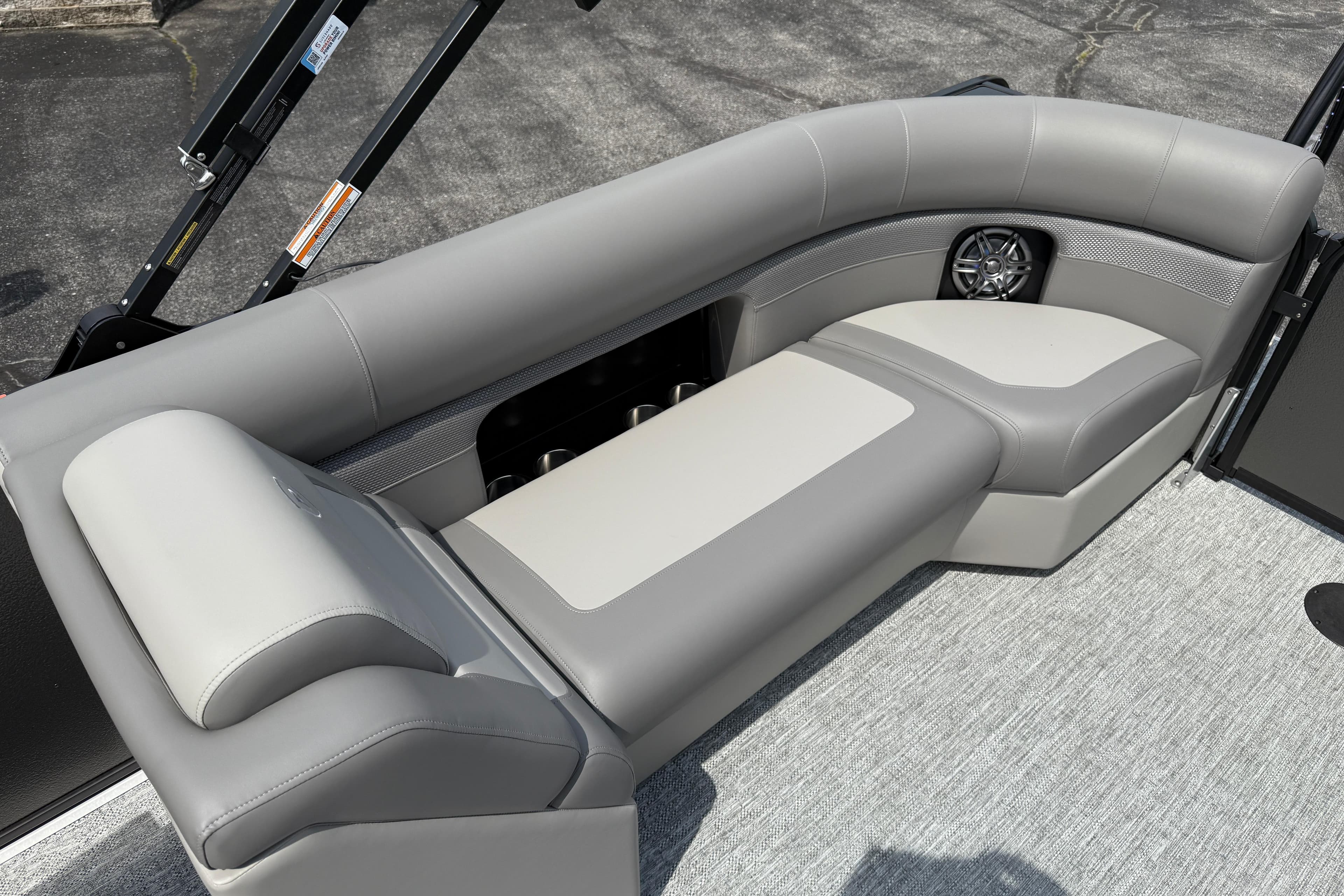 2026 Premier 230 SunSation RF boat interior with gray cushioned seating and speaker.
