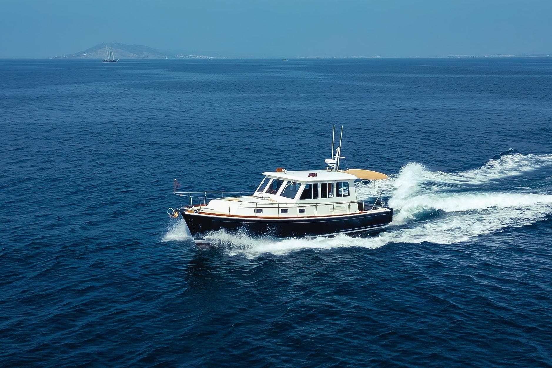 1998 Grand Banks 43 Eastbay EX cruising on open blue sea.