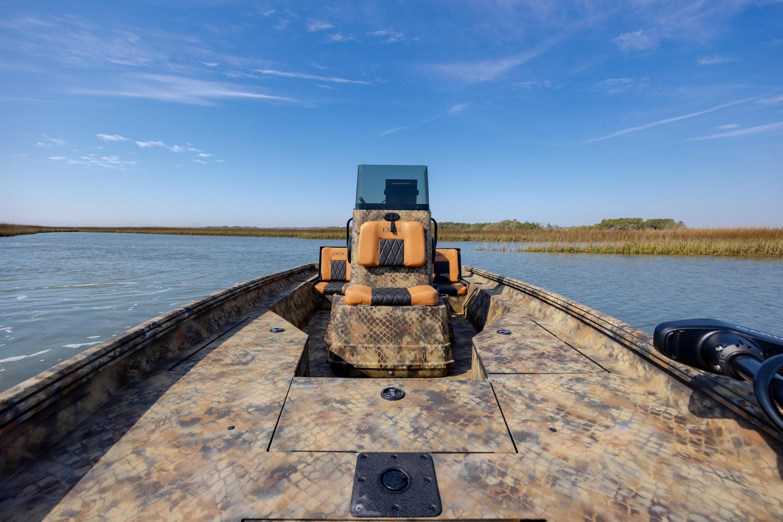 2026 Excel 203 Bay Pro Elite boat on calm water with clear blue sky.